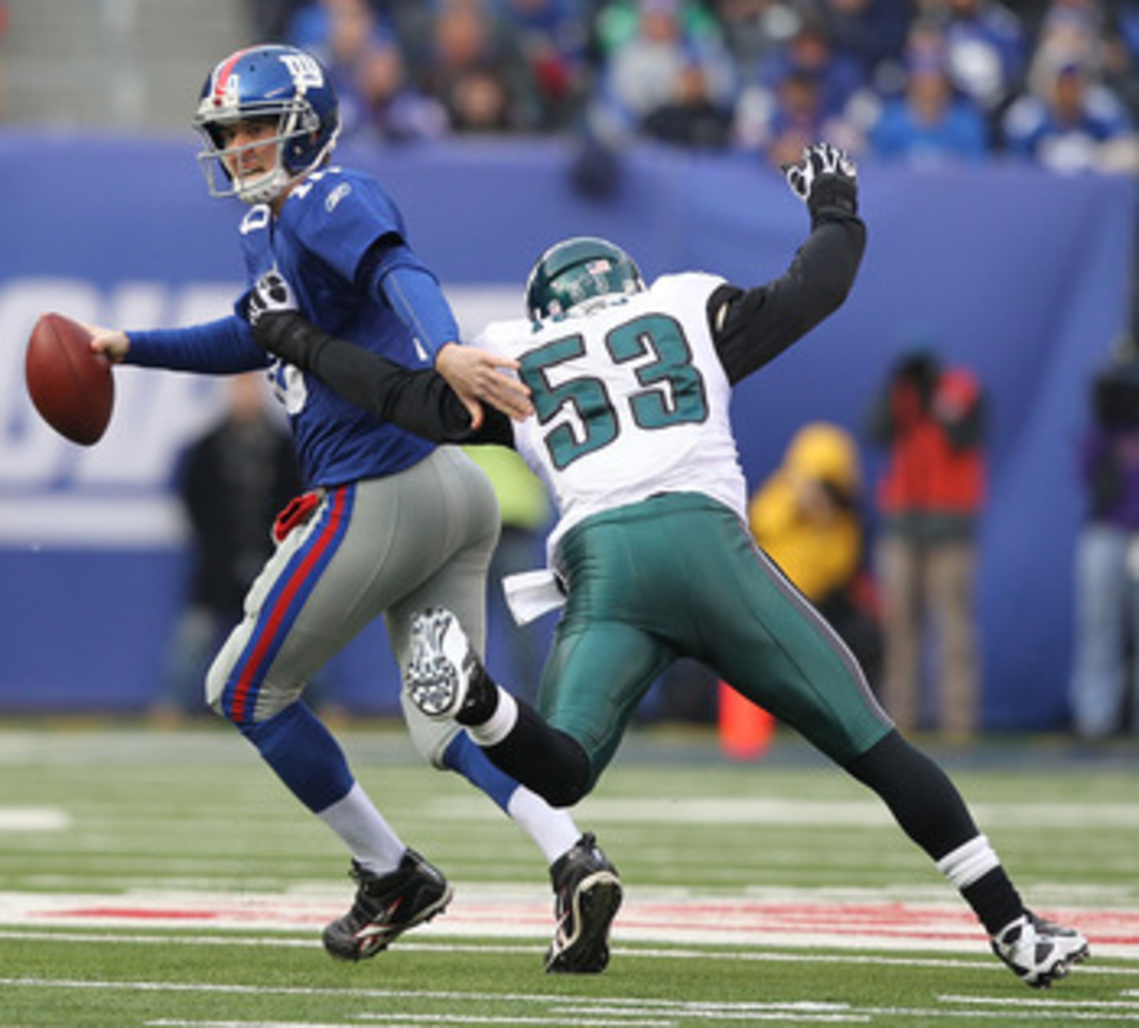 EAST RUTHERFORD, NJ - DECEMBER 19:  Eli Manning #10 of the New York Giants is sacked by Moise Fokou #53 of the Philadelphia Eagles during their game on December 19, 2010 at The New Meadowlands Stadium in East Rutherford, New Jersey.  (Photo by Al Bello/Ge