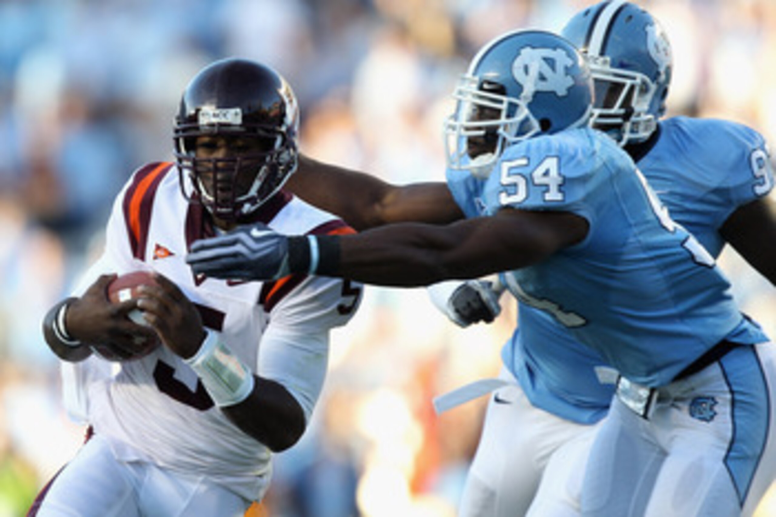 CHAPEL HILL, NC - NOVEMBER 13: Tyrod Taylor #5 of the Virginia Tech Hokies is tackled by Bruce Carter #54 and teammate Jared McAdoo #97 of the North Carolina Tar Heels during their game at Kenan Stadium on November 13, 2010 in Chapel Hill, North Carolina CHAPEL HILL, NC - NOVEMBER 13: Tyrod Taylor #5 of the Virginia Tech Hokies is tackled by Bruce Carter #54 and teammate Jared McAdoo #97 of the North Carolina Tar Heels during their game at Kenan Stadium on November 13, 2010 in Chapel Hill, North Carolina