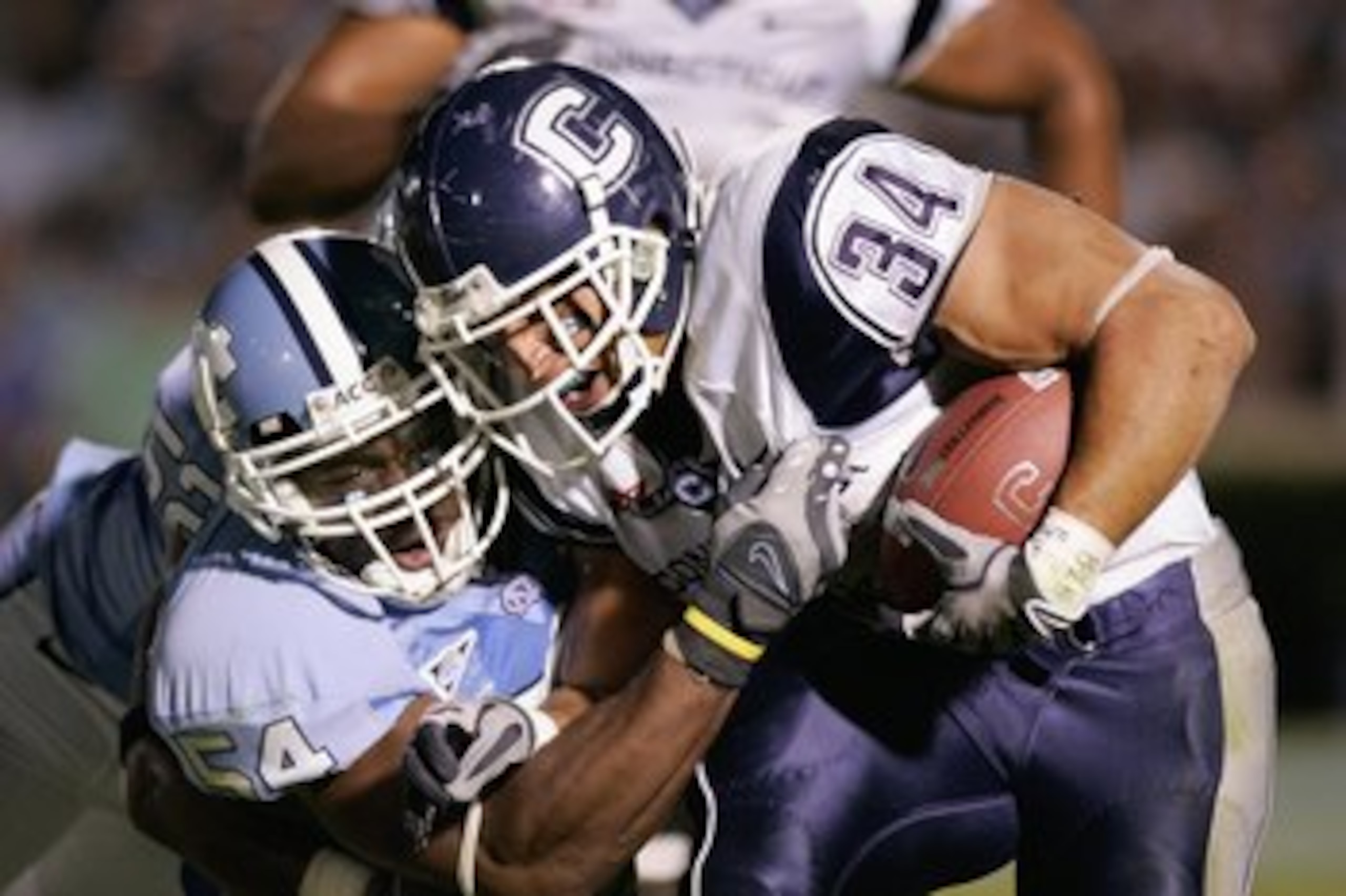 CHAPEL HILL, NC - OCTOBER 4: Donald Brown #34 of the Connecticut Huskies carries the ball against Bruce Carter #54 of the North Carolina Tar Heels during the game at Kenan Stadium on October 4, 2008 in Chapel Hill, North Carolina. (Photo by Kevin C. Cox CHAPEL HILL, NC - OCTOBER 4: Donald Brown #34 of the Connecticut Huskies carries the ball against Bruce Carter #54 of the North Carolina Tar Heels during the game at Kenan Stadium on October 4, 2008 in Chapel Hill, North Carolina. (Photo by Kevin C. Cox