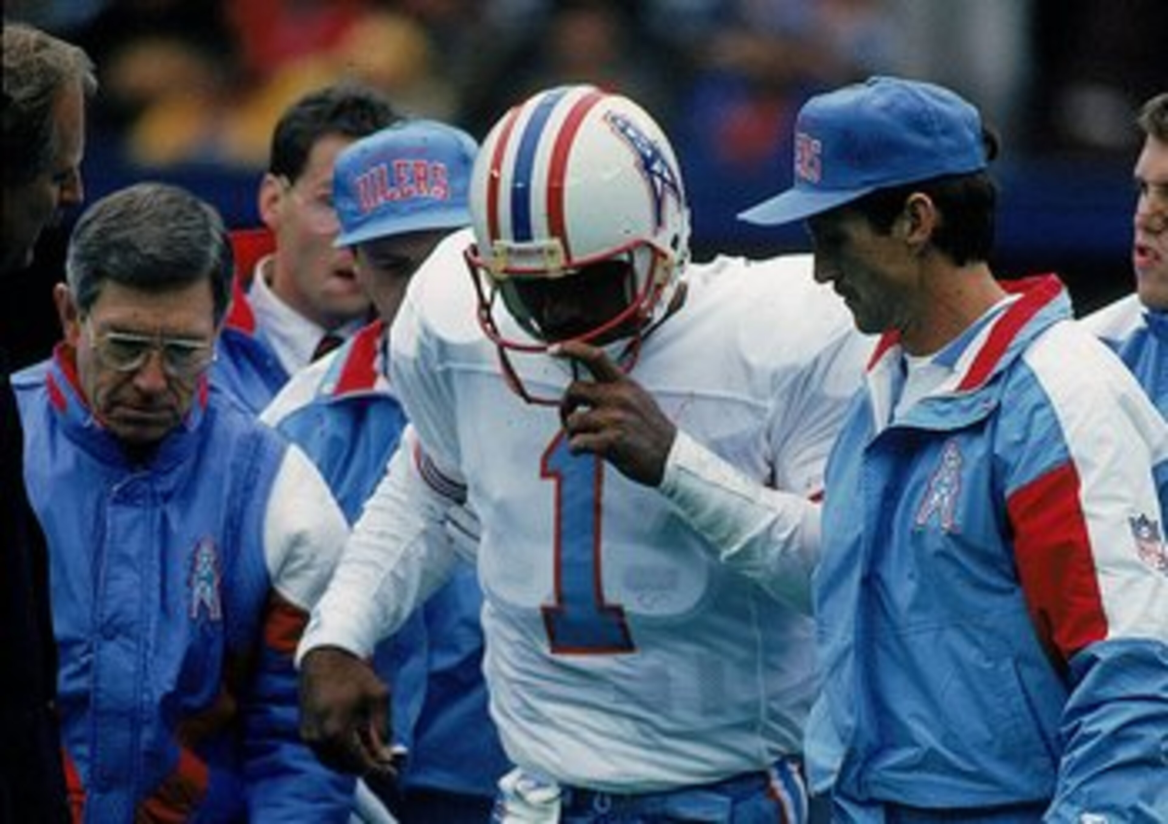 4 Nov 1992:  Quarterback Warren Moon #1 of the Oilers is injured during a game and helped off the field. Mandatory Credit: Jonathan Daniel  /Allsport