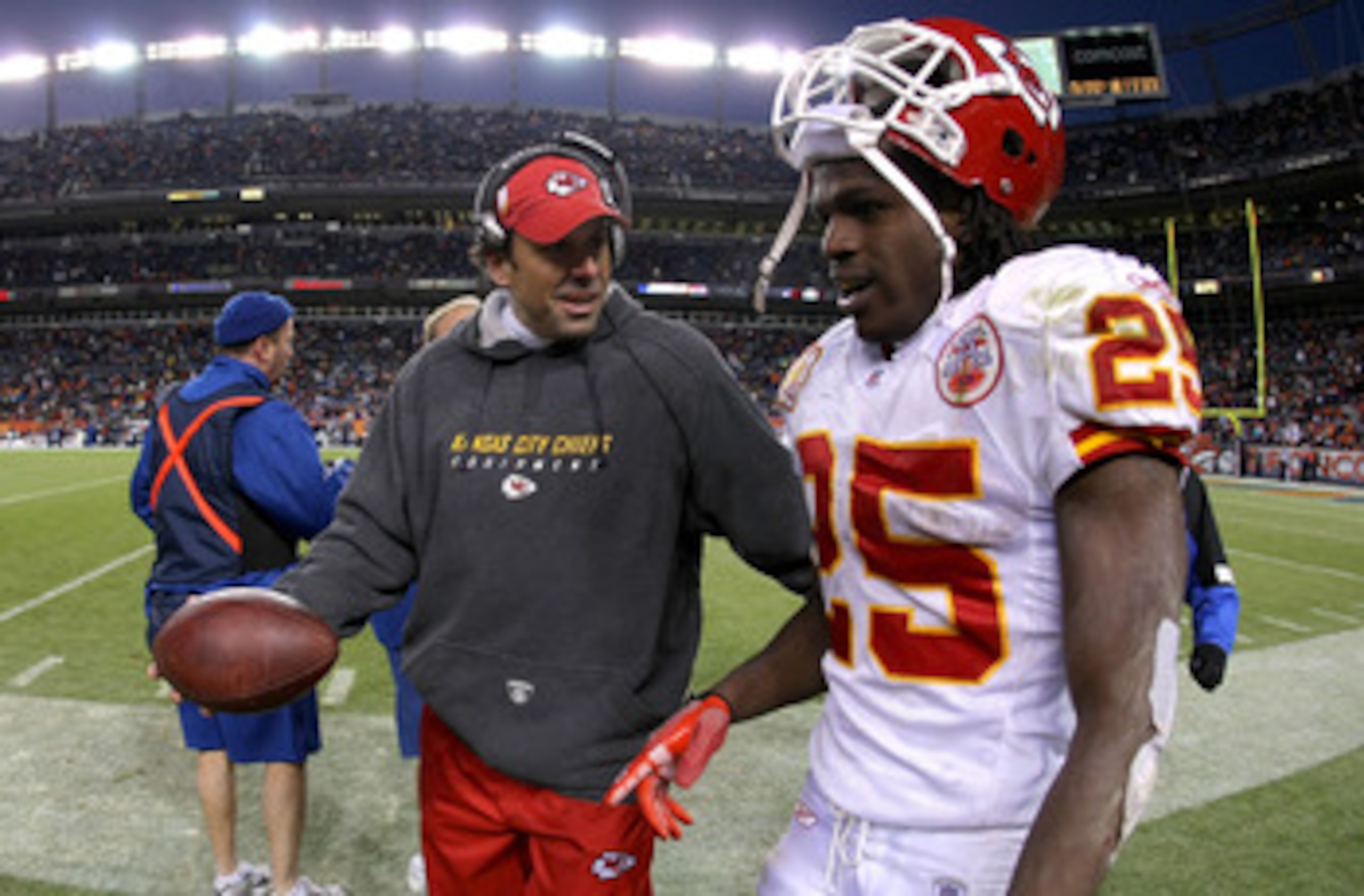 DENVER - JANUARY 03: Jamaal Charles #25 of the Kansas City Chiefs is offered the ball by head coach Todd Haley after Charles scored on a 56 yard fourth quarter touchdown run against the Denver Broncos during NFL action at Invesco Field at Mile High on Jan