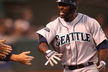 OAKLAND, CA - APRIL 02:  Milton Bradley #15 of the Seattle Mariners scores on a single by Jack Cust in the sixth inning against the Oakland Athletics during a Major League Baseball game at the Oakland-Alameda County Coliseum on April 2, 2011 in Oakland, C