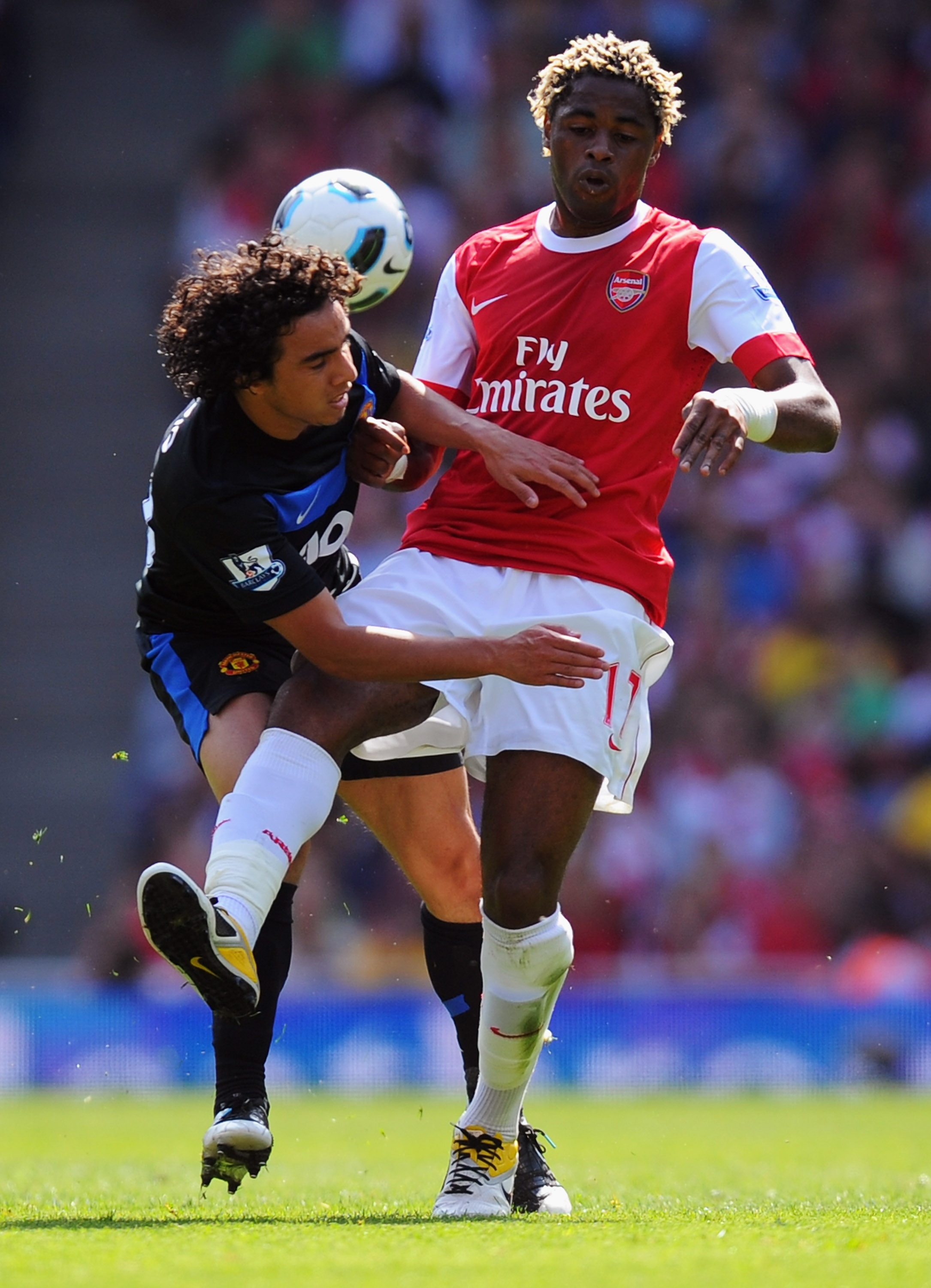 LONDON, ENGLAND - MAY 01:  Alex Song of Arsenal tangles with Fabio Da Silva of Manchester United during the Barclays Premier League match between Arsenal and Manchester United at the Emirates Stadium on May 1, 2011 in London, England.  (Photo by Mike Hewi