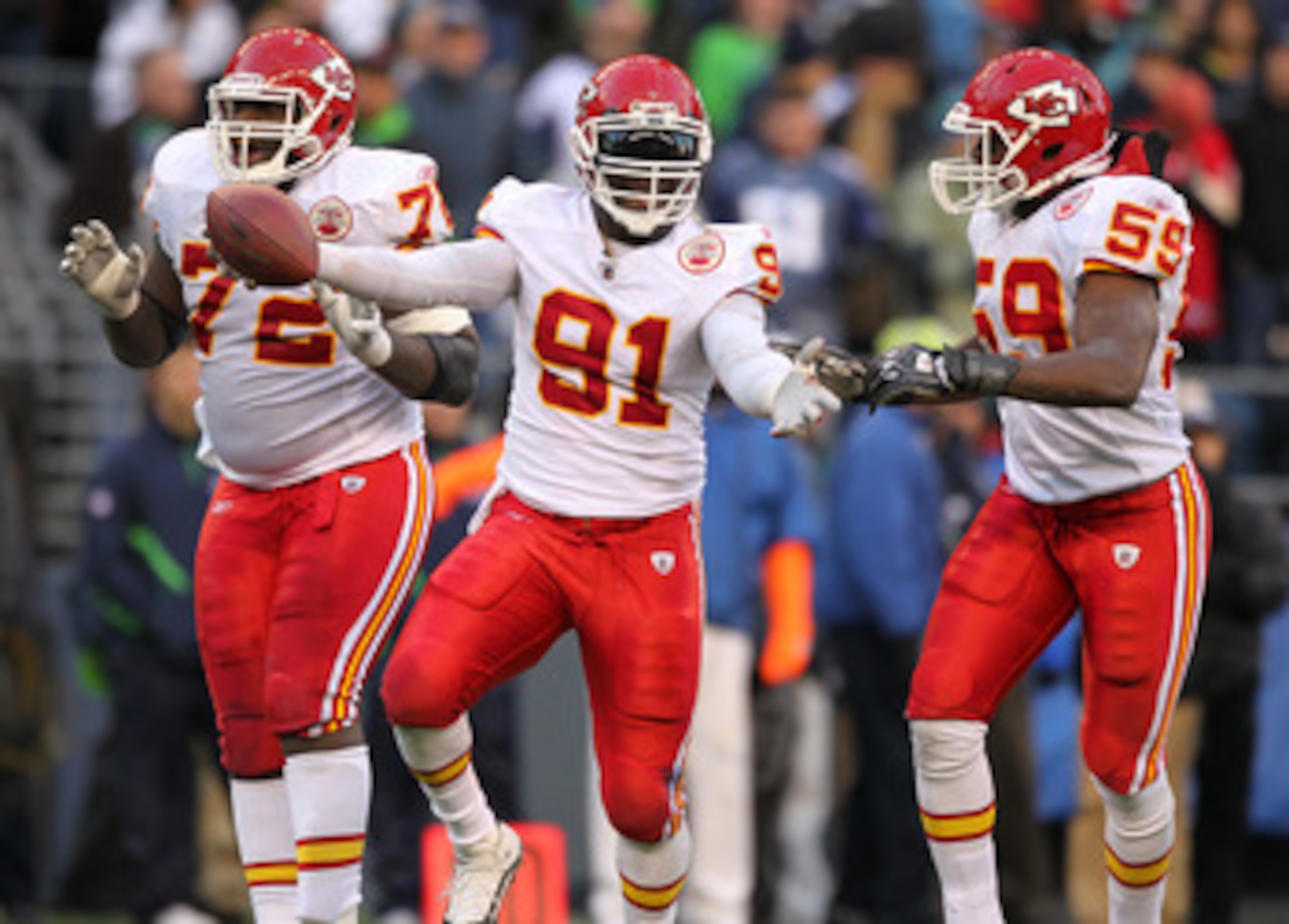 SEATTLE, WA - NOVEMBER 28:  Linebacker Tamba Hali #91 of the Kansas City Chiefs celebrates with Glenn Dorsey #72 and Jovan Belcher #59 after recovering a fumble on a sack of quarterback Matt Hasselbeck of the Seattle Seahawks at Qwest Field on November 28