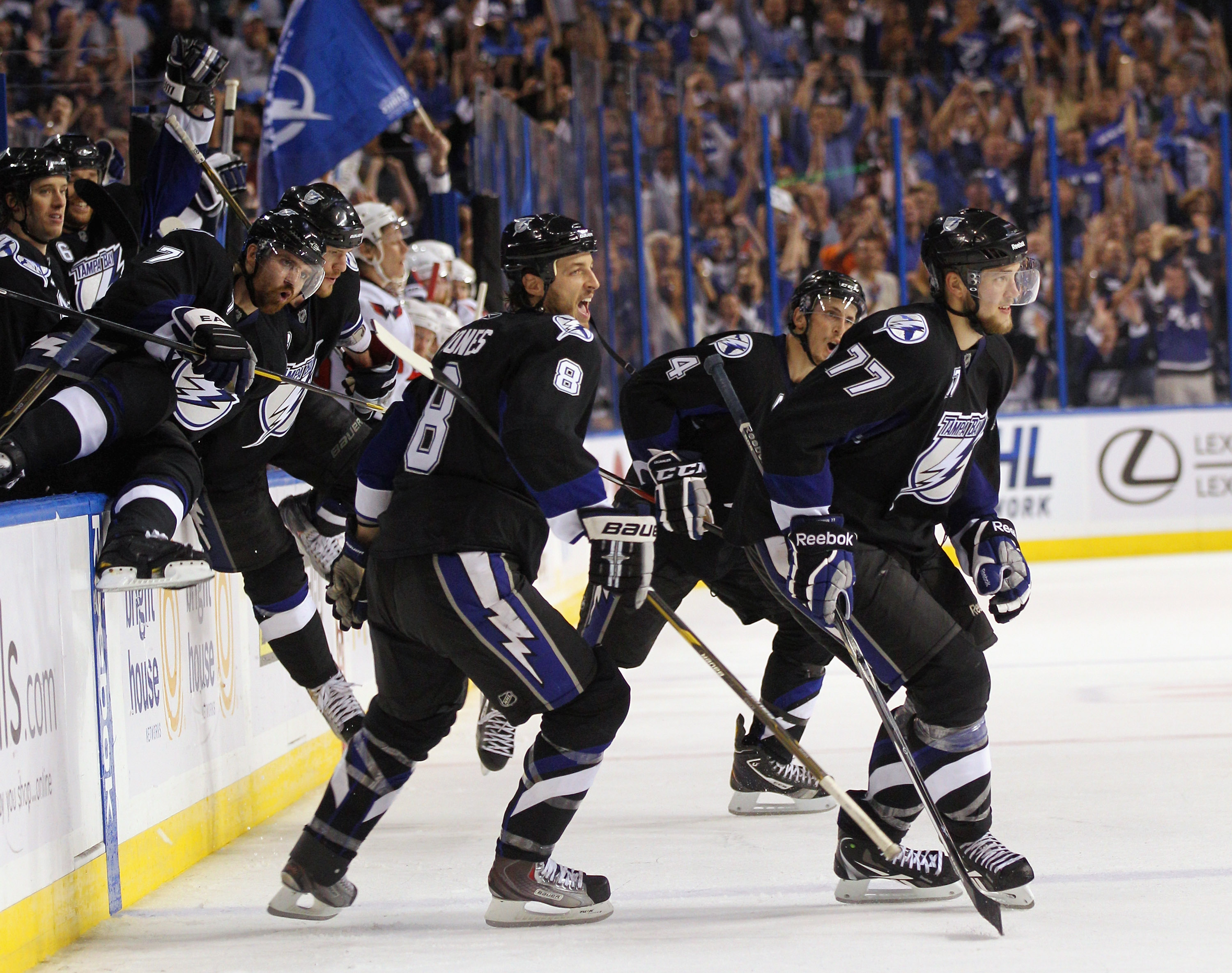 TAMPA, FL - MAY 04:  Randy Jones #8, Victor Hedman #77, and the Tampa Bay Lightning celebrate their 5-3 victory over the Washington Capitals in Game Four of the Eastern Conference Semifinals during the 2011 NHL Stanley Cup Playoffs at the St Pete Times Fo