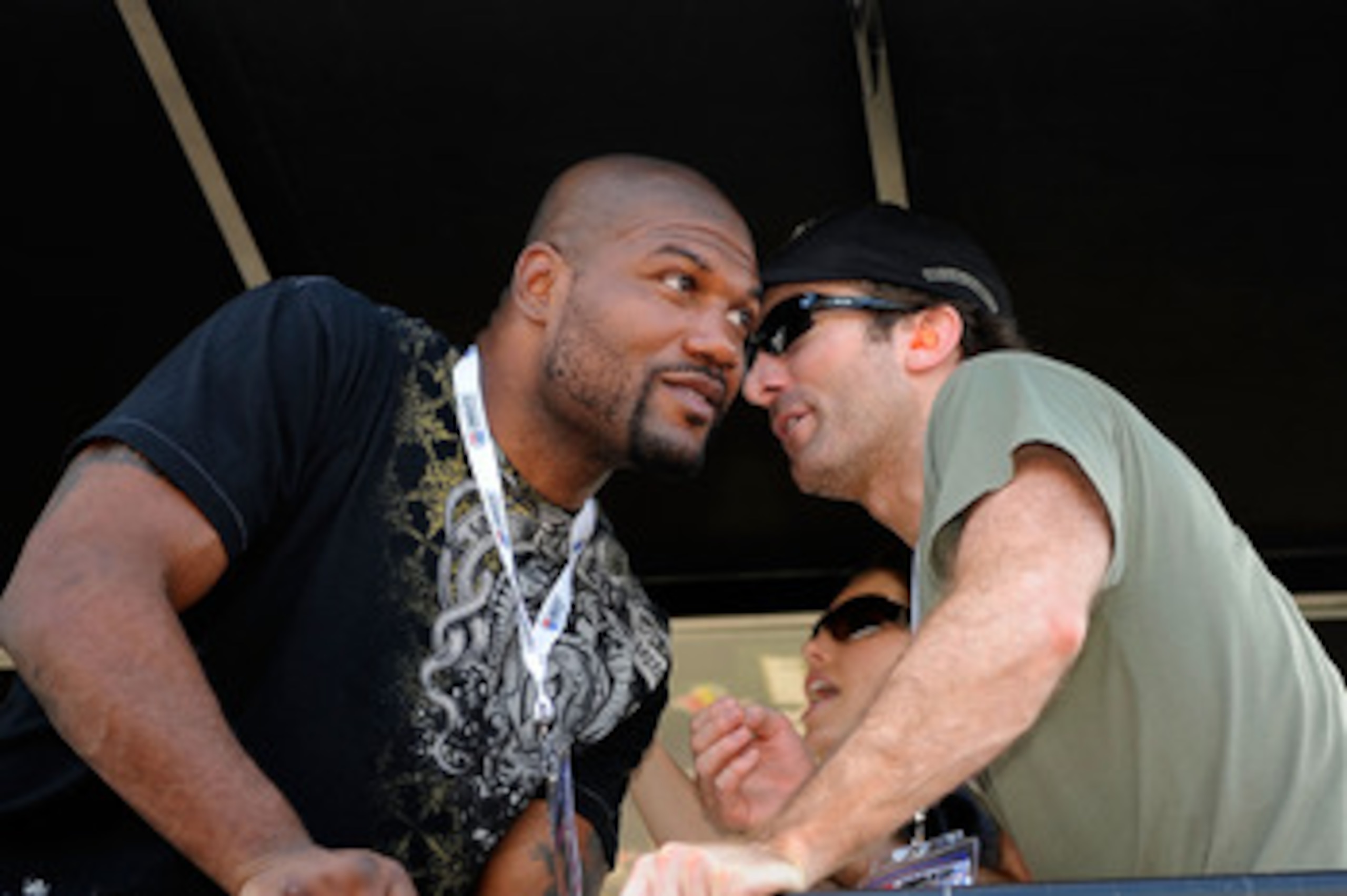 CONCORD, NC - MAY 30:  Actors Sharlto Copley (R) and Quinton 'Rampage' Jackson talk in the #39 U.S. Army Chevrolet pit box prior to the NASCAR Sprint Cup Series Coca-Cola 600 at Charlotte Motor Speedway on May 30, 2010 in Concord, North Carolina.  (Photo