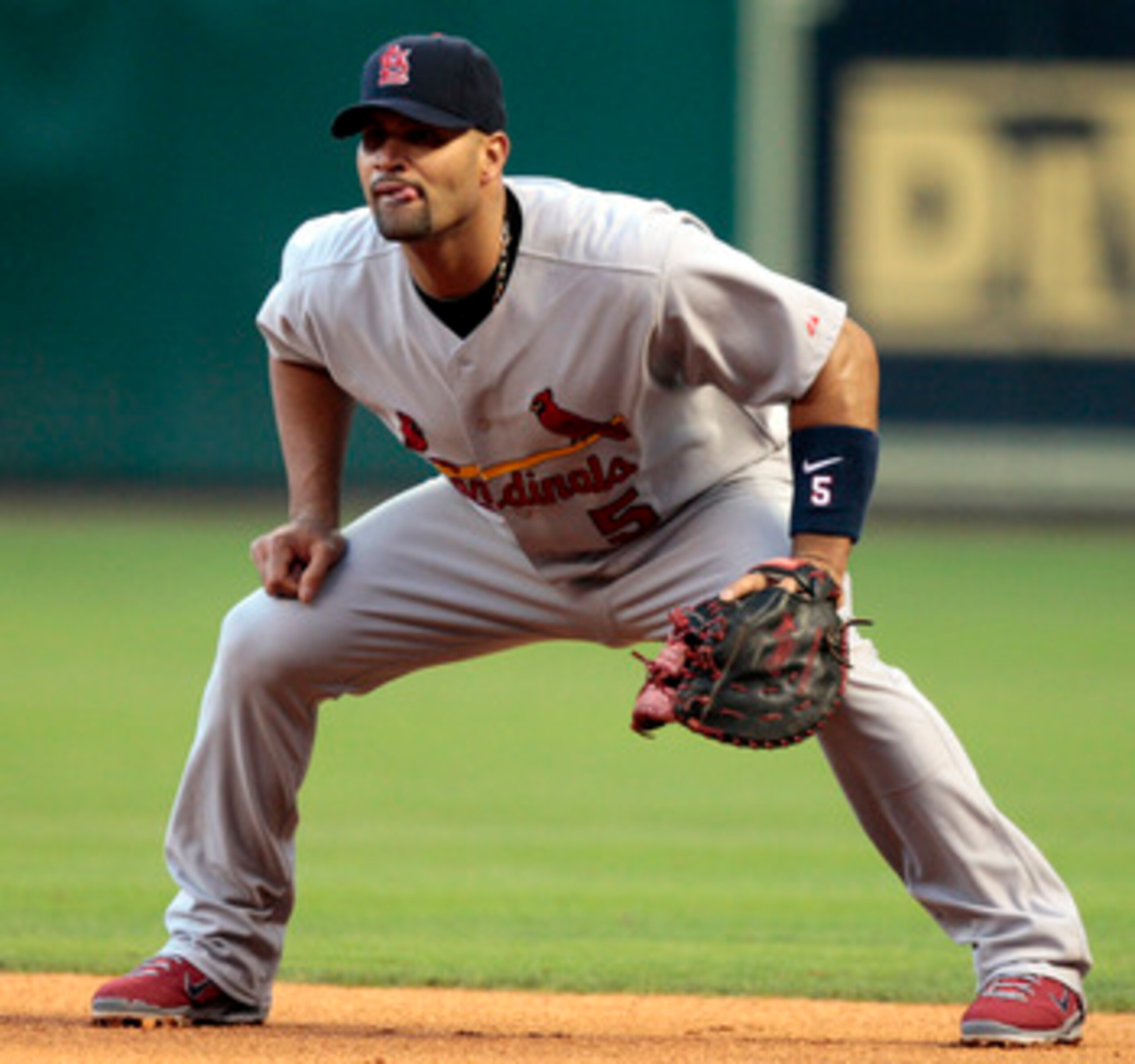 HOUSTON - APRIL 27:  First baseman Albert Pujols #5 of the St. Louis Cardinals waits for the next batter against the Houston Astros at Minute Maid Park on April 27, 2011 in Houston, Texas.  (Photo by Bob Levey/Getty Images)