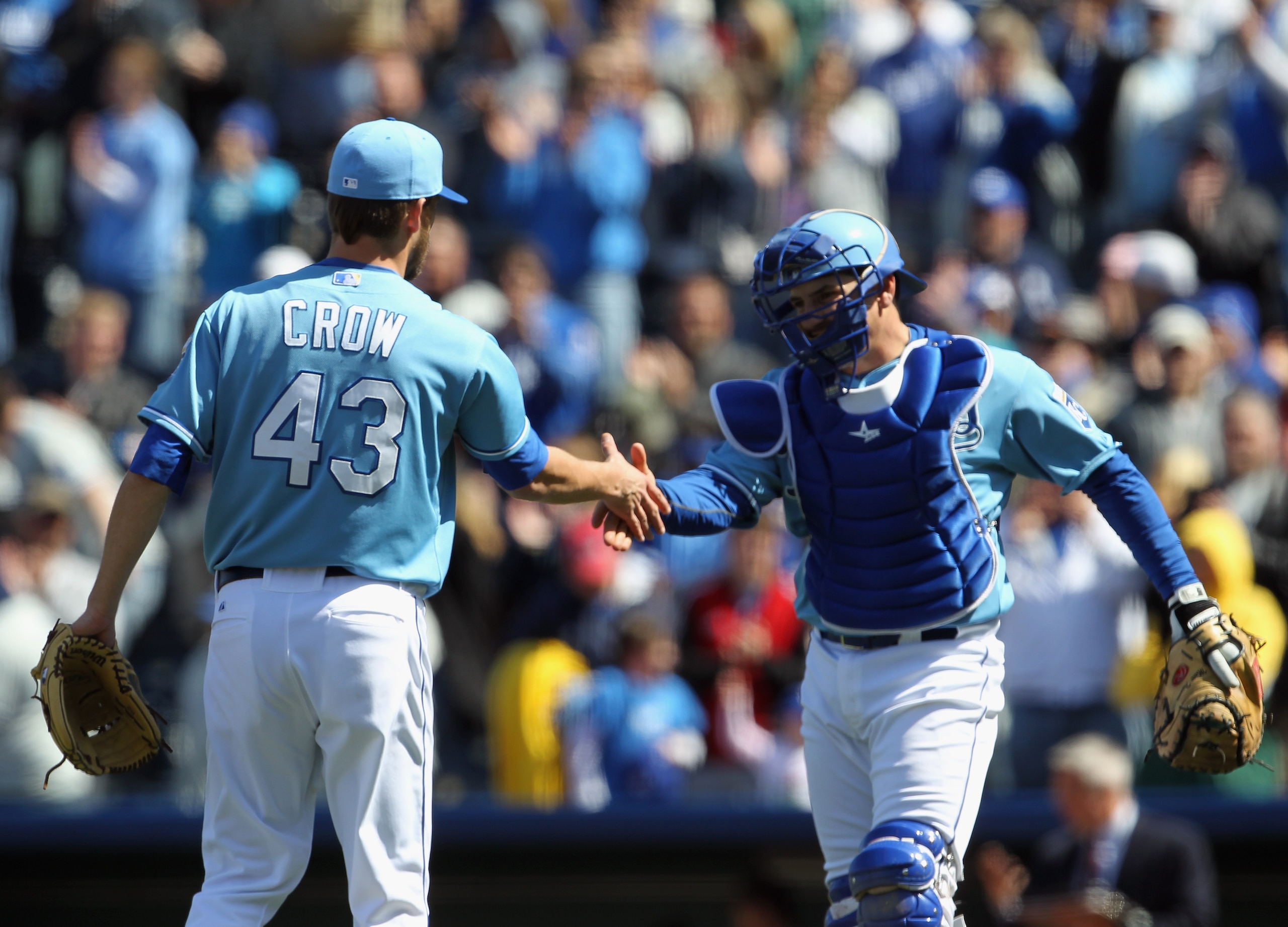 KANSAS CITY, MO - APRIL 16:  Closing pitcher Aaron Crow #43 of the Kansas City Royals is congratulated by Matt Treanor #15 after the Royals defeated the Seattle Mariners 7-0 to win the game on April 16, 2011 at Kauffman Stadium in Kansas City, Missouri.