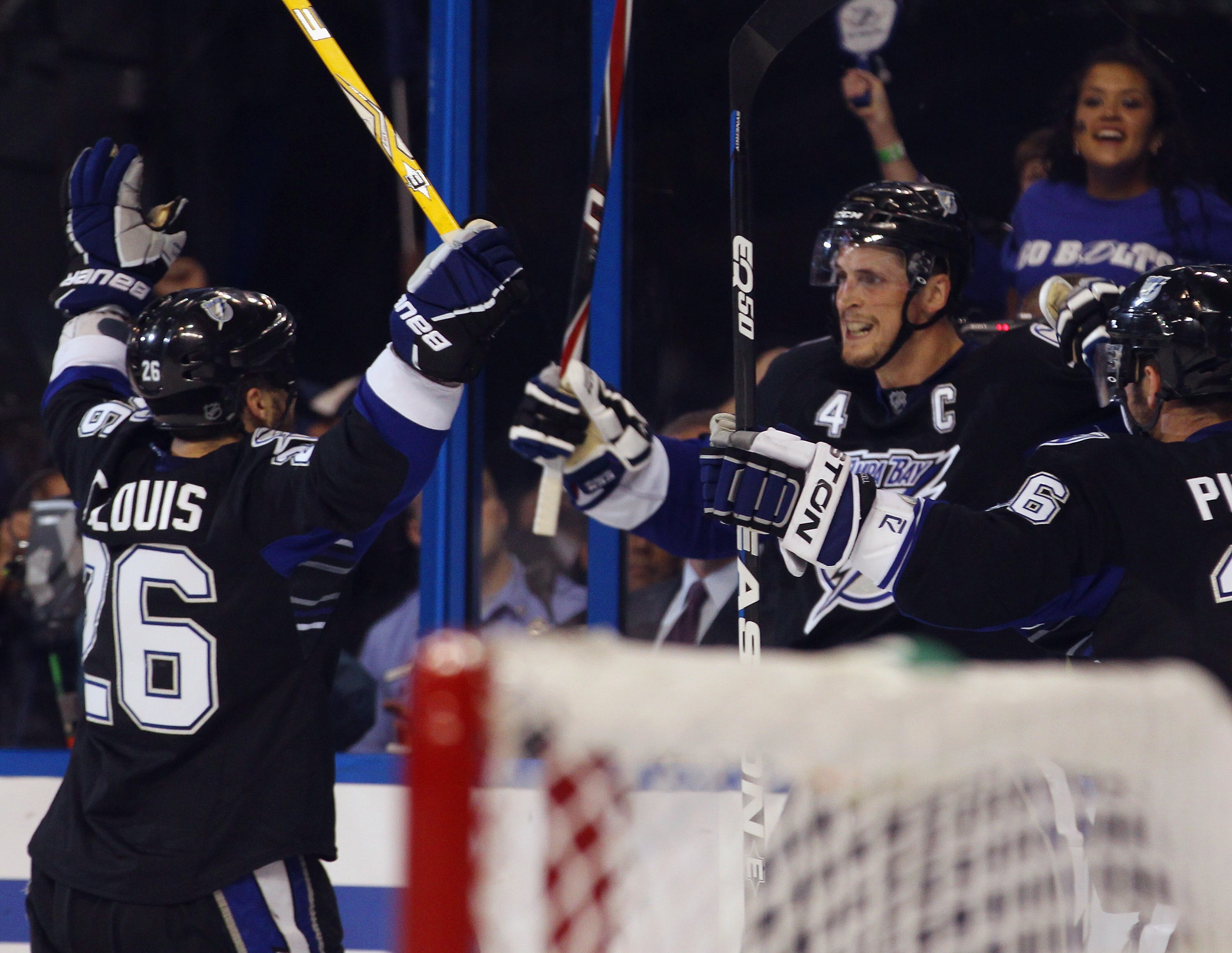 TAMPA, FL - MAY 03: Martin St. Louis #26 of the Tampa Bay Lightning and Vincent Lecavalier #4 of the Tampa Bay Lightning celebrate a second period goal by Lecavalier against the Washington Capitals  in Game Three of the Eastern Conference Semifinals durin
