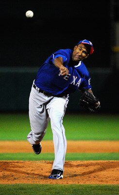 SCOTTSDALE, AZ - MARCH 07:  Pitcher Alexi Ogando #41 of the Texas Rangers throws a pitch against the San Francisco Giants in the first meeting between the two teams since the World Series during the spring training game at Scottsdale Stadium on March 7, 2