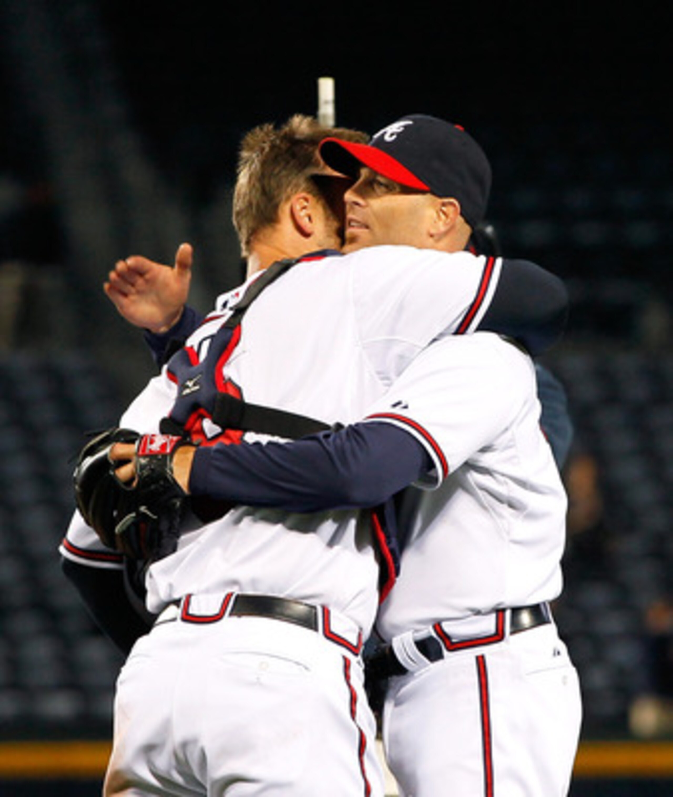ATLANTA, GA - MAY 04:  Tim Hudson #15 of the Atlanta Braves celebrates with David Ross #8 after pitching a one-hit shutout to give the Braves an 8-0 win over the Milwaukee Brewers at Turner Field on May 4, 2011 in Atlanta, Georgia.  (Photo by Kevin C. Cox