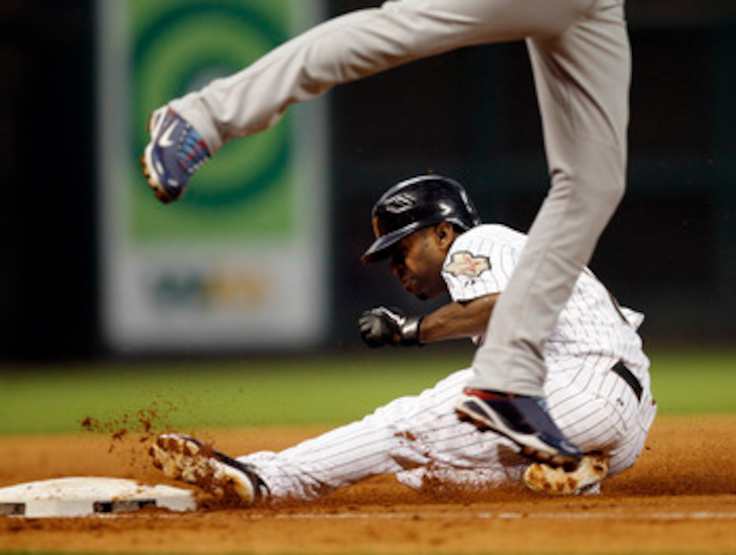 HOUSTON - APRIL 12:  Houston Astros' Michael Bourn #21 steals third base against the Chicago Cubs at Minute Maid Park on April 12, 2011 in Houston, Texas.  (Photo by Bob Levey/Getty Images)