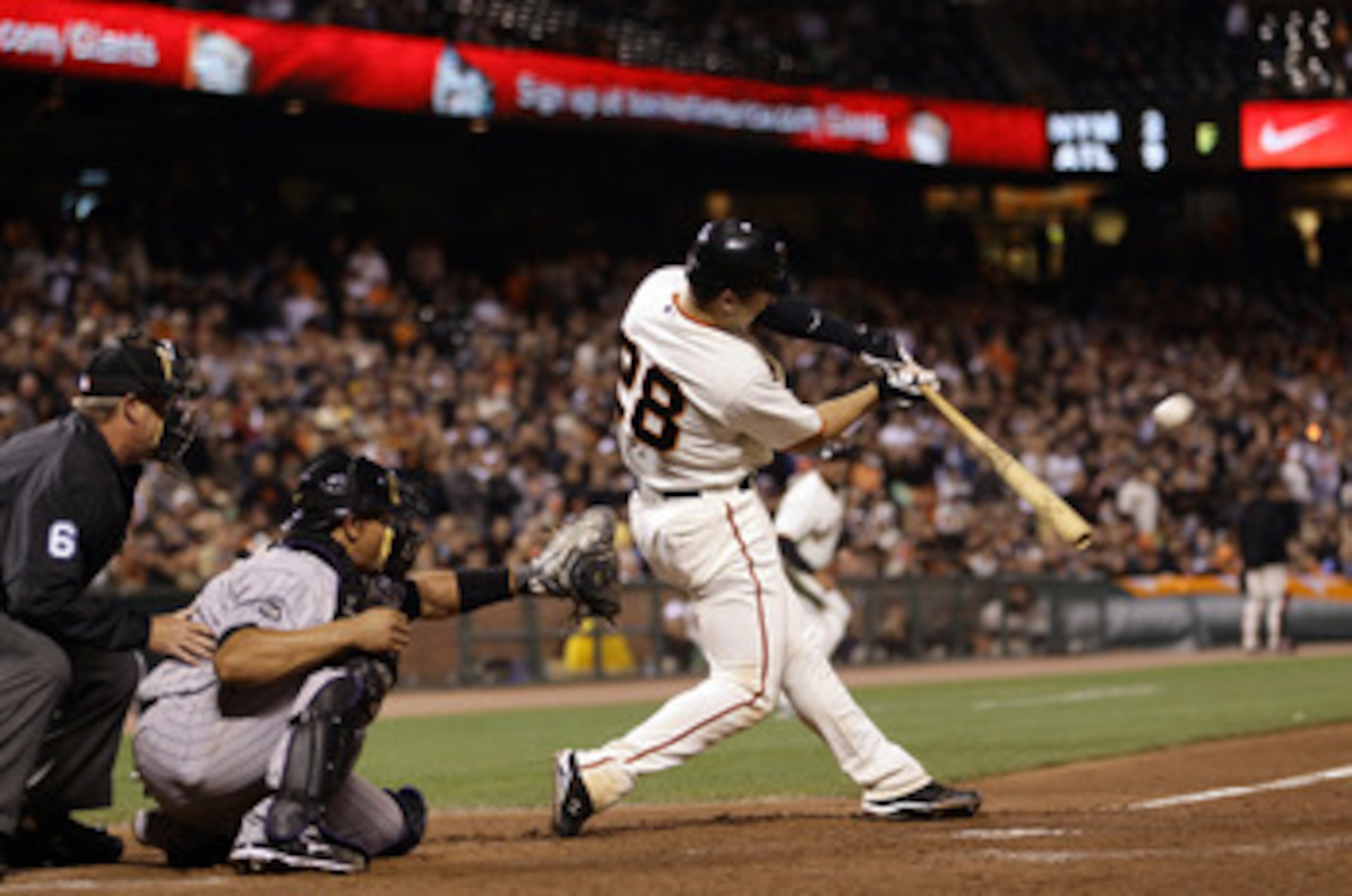 SAN FRANCISCO - AUGUST 31:  Buster Posey #28 of the San Francisco Giants hits a double that scored Freddy Sanchez and Pat Burrell in the eighth inning against the Colorado Rockies at AT&T Park on August 31, 2010 in San Francisco, California.  (Photo by Ez