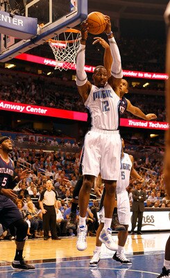 ORLANDO, FL - APRIL 26:  Dwight Howard #12 of the Orlando Magic rebounds against the Atlanta Hawks during Game Five of the Eastern Conference Quarterfinals of the 2011 NBA Playoffs on April 26, 2011 at the Amway Arena in Orlando, Florida.  NOTE TO USER: U