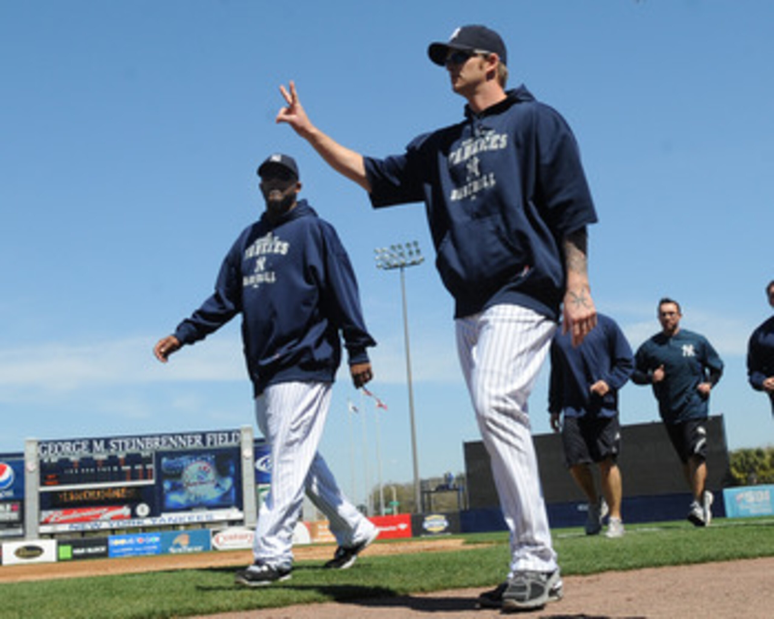 TAMPA, FL - MARCH 5: Pitchers A. J. Burnett #34 and CC Sabathia  #52 of the New York Yankees walk to the dugout before play  against the Tampa Bay Rays March 5, 2010 at the George M. Steinbrenner  Field in Tampa, Florida. (Photo by Al Messerschmidt/Getty