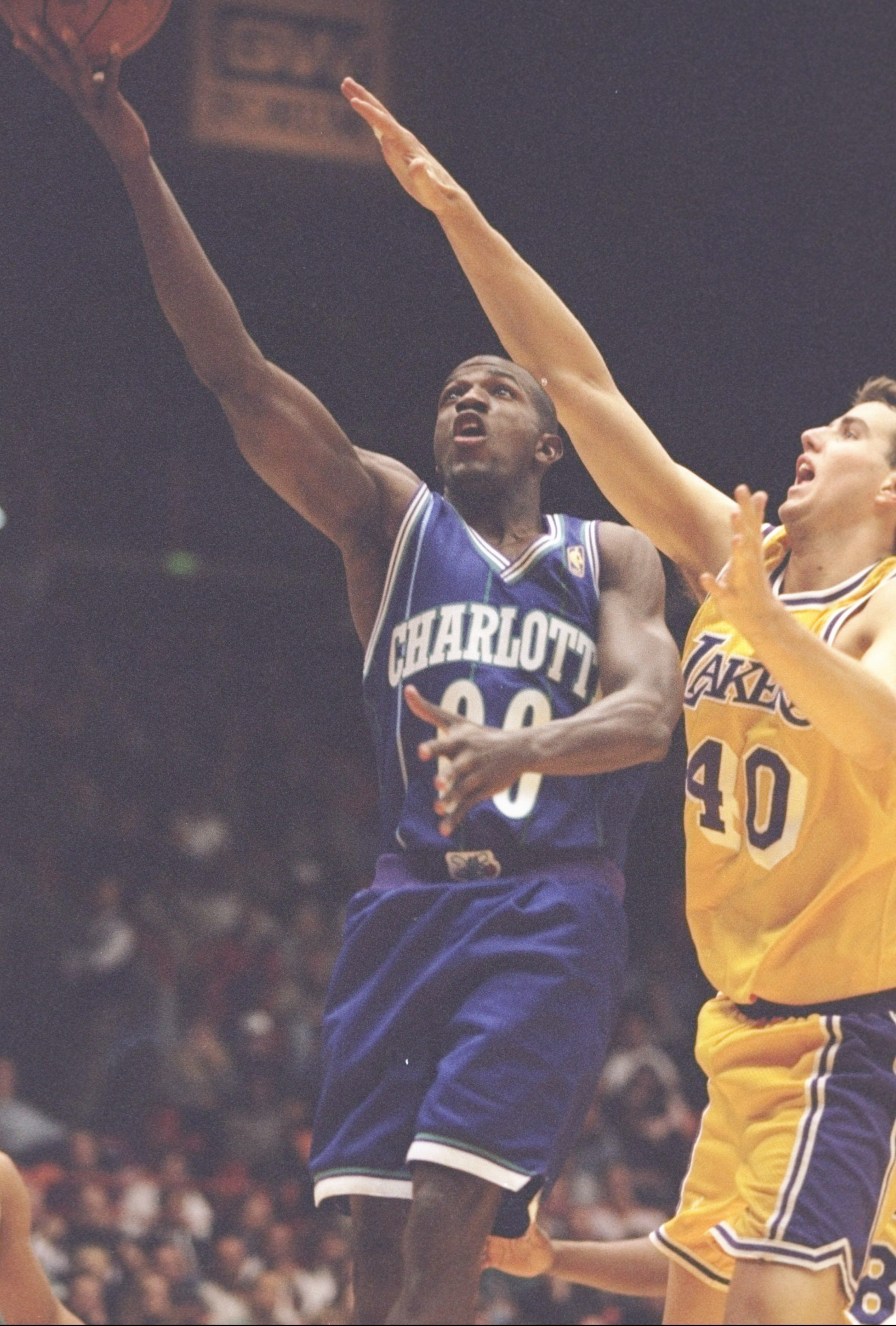 8 Jan 1997: Guard Tony Delk of the Charlotte Hornets drives past center Travis Knight of the Los Angeles Lakers at the Great Western Forum in Inglewood, California. The Lakers won the game 101-97. Mandatory Credit: Brian Bahr /Allsport 8 Jan 1997: Guard Tony Delk of the Charlotte Hornets drives past center Travis Knight of the Los Angeles Lakers at the Great Western Forum in Inglewood, California. The Lakers won the game 101-97. Mandatory Credit: Brian Bahr /Allsport