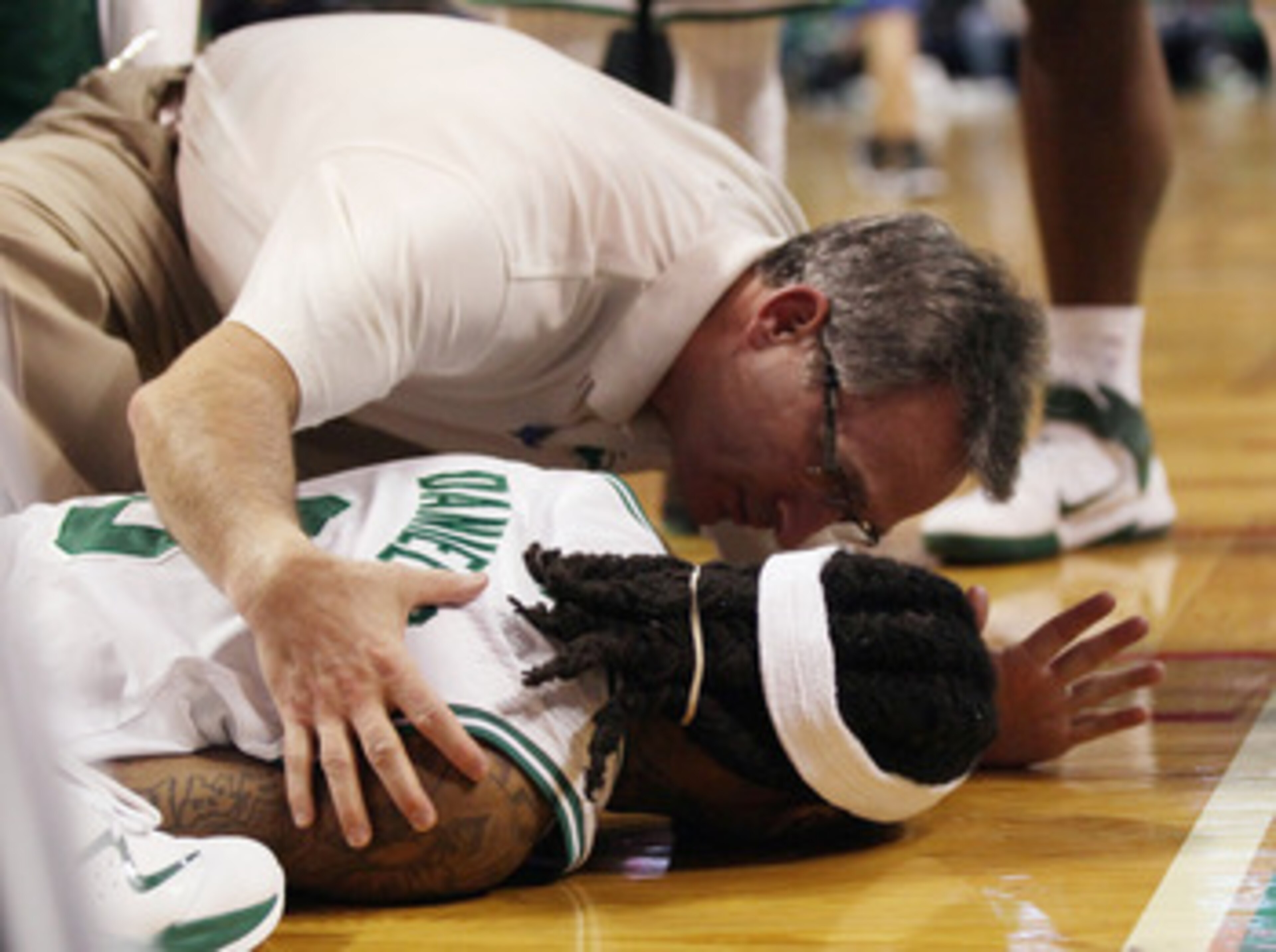 BOSTON, MA - FEBRUARY 06:  Marquis Daniels #8 the Boston Celtics is cared for after he collided with Gilbert Arenas #1 of the Orlando Magic on February 6, 2011 at the TD Garden in Boston, Massachusetts.  NOTE TO USER: User expressly acknowledges and agree