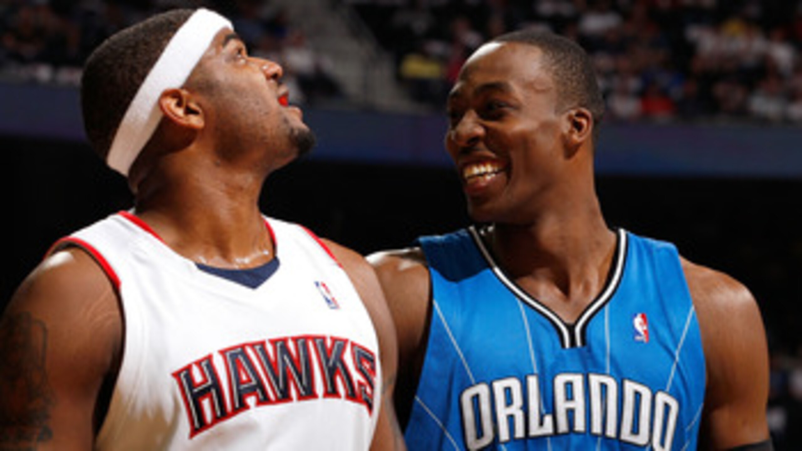 ATLANTA - MAY 10:  Dwight Howard #12 of the Orlando Magic enjoys a laugh at a parody about him on the big screen next to Josh Smith #5 of the Atlanta Hawks during Game Four of the Eastern Conference Semifinals of the 2010 NBA Playoffs at Philips Arena on