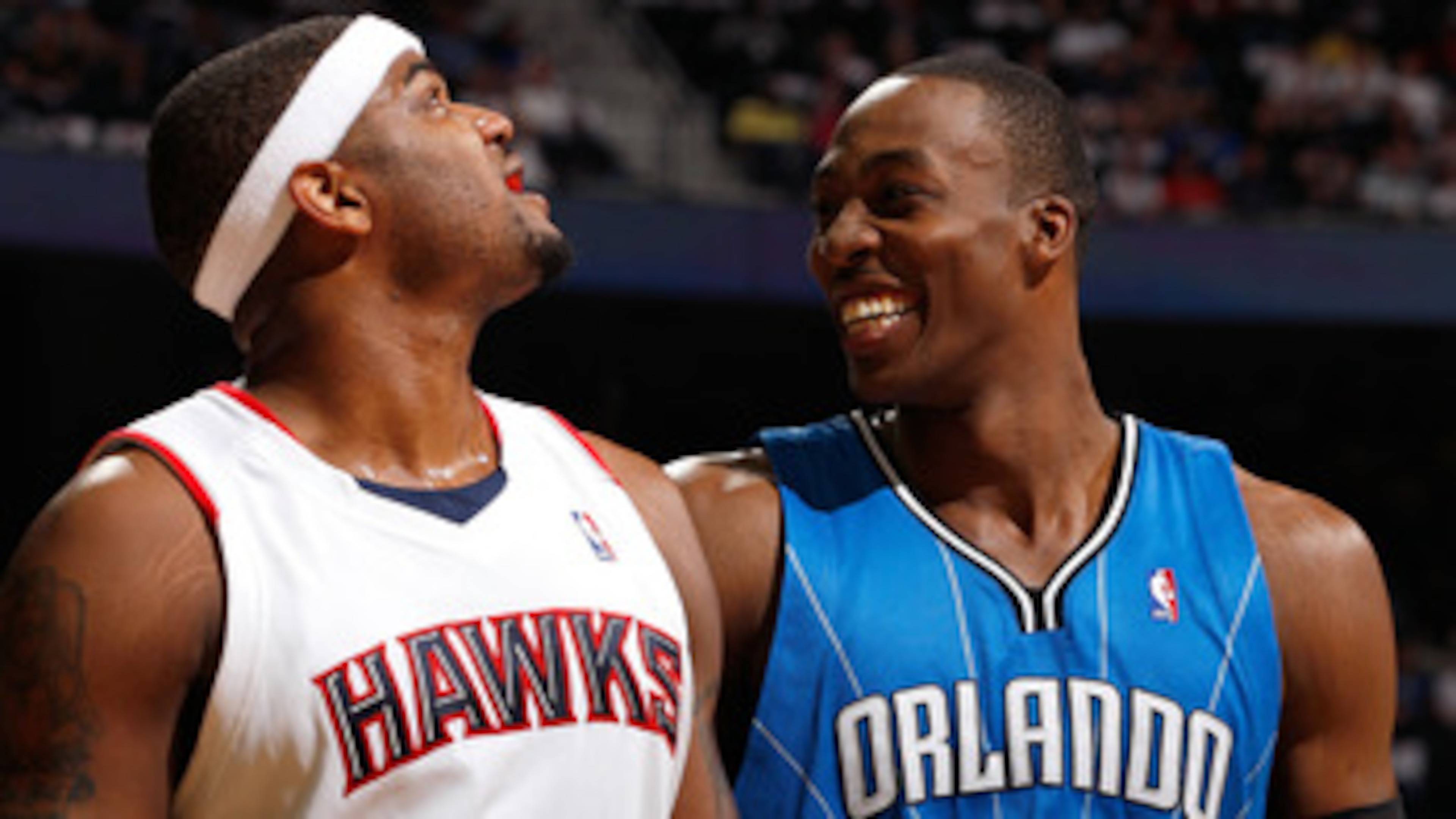 ATLANTA - MAY 10:  Dwight Howard #12 of the Orlando Magic enjoys a laugh at a parody about him on the big screen next to Josh Smith #5 of the Atlanta Hawks during Game Four of the Eastern Conference Semifinals of the 2010 NBA Playoffs at Philips Arena on
