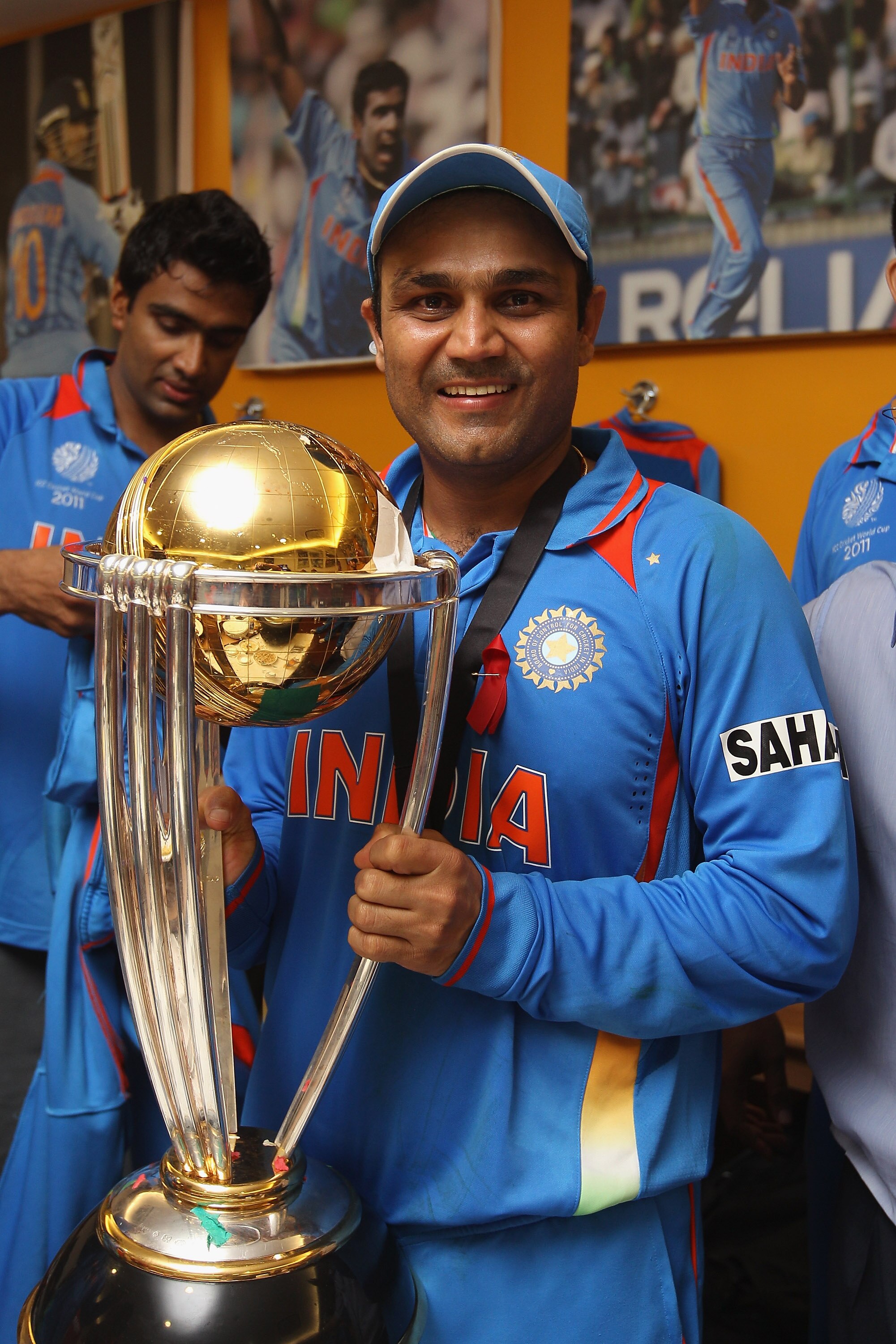MUMBAI, INDIA - APRIL 02:  Virender Sehwag of India poses with the World Cup trophy in the players dressing room after his side's six wicket victory in the 2011 ICC World Cup Final between India and Sri Lanka at Wankhede Stadium on April 2, 2011 in Mumbai
