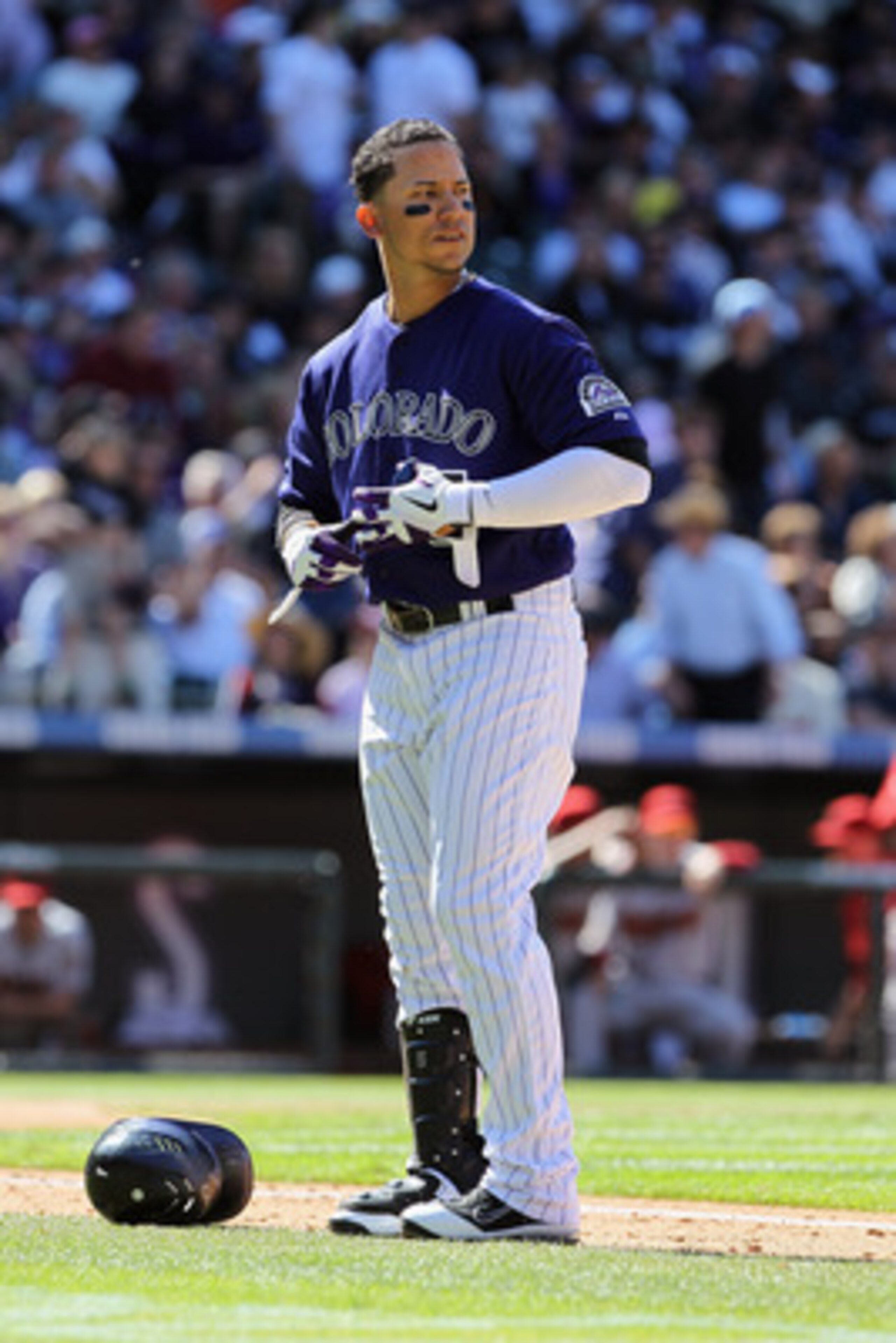 DENVER, CO - APRIL 01:  Carlos Gonzalez #5 of the Colorado Rockies looks on against the Arizona Diamondbacks during Opening Day at Coors Field on April 1, 2011 in Denver, Colorado. The Diamondbacks defeated the Rockies 7-6 in 11 innings.  (Photo by Doug P