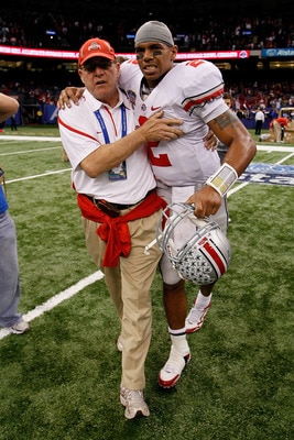 NEW ORLEANS, LA - JANUARY 04: (M) Quarterback Terrelle Pryor #2 of the Ohio State Buckeyes is helped off the field by a member of the Buckeyes support team after the Buckeyes 31-26 victory against the Arkansas Razorbacks during the Allstate Sugar Bowl at NEW ORLEANS, LA - JANUARY 04: (M) Quarterback Terrelle Pryor #2 of the Ohio State Buckeyes is helped off the field by a member of the Buckeyes support team after the Buckeyes 31-26 victory against the Arkansas Razorbacks during the Allstate Sugar Bowl at
