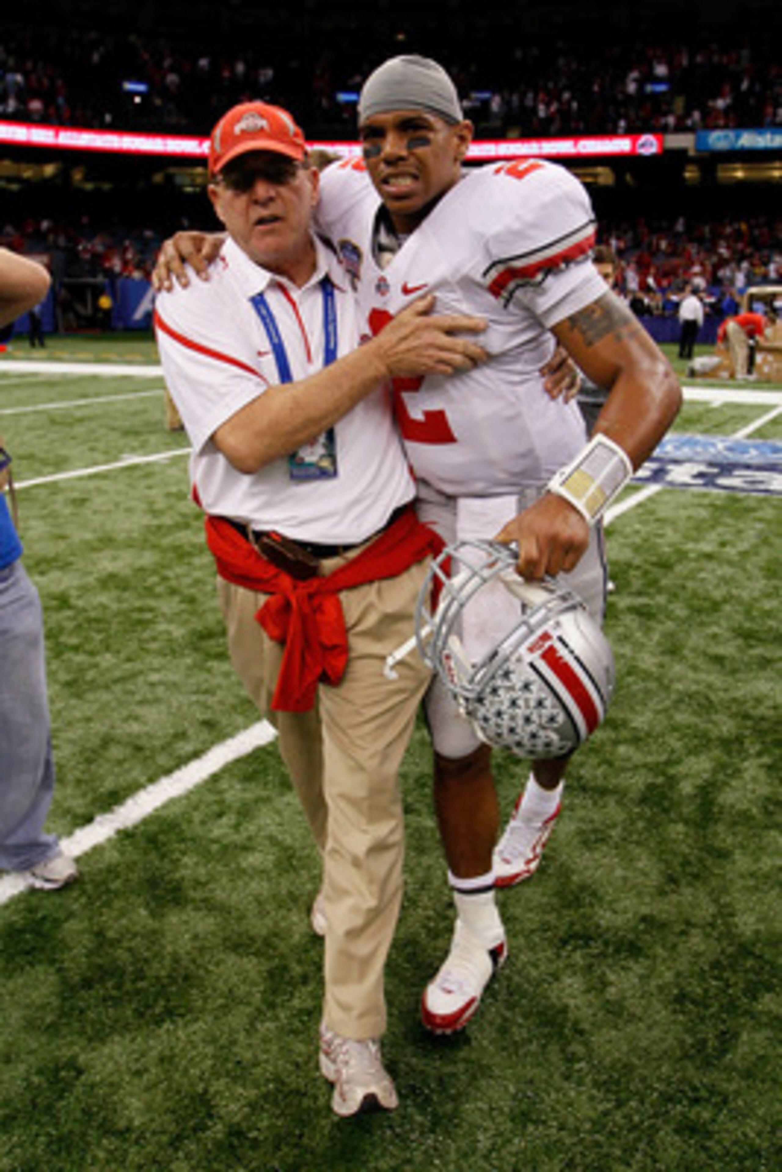 NEW ORLEANS, LA - JANUARY 04: (M) Quarterback Terrelle Pryor #2 of the Ohio State Buckeyes is helped off the field by a member of the Buckeyes support team after the Buckeyes 31-26 victory against the Arkansas Razorbacks during the Allstate Sugar Bowl at NEW ORLEANS, LA - JANUARY 04: (M) Quarterback Terrelle Pryor #2 of the Ohio State Buckeyes is helped off the field by a member of the Buckeyes support team after the Buckeyes 31-26 victory against the Arkansas Razorbacks during the Allstate Sugar Bowl at