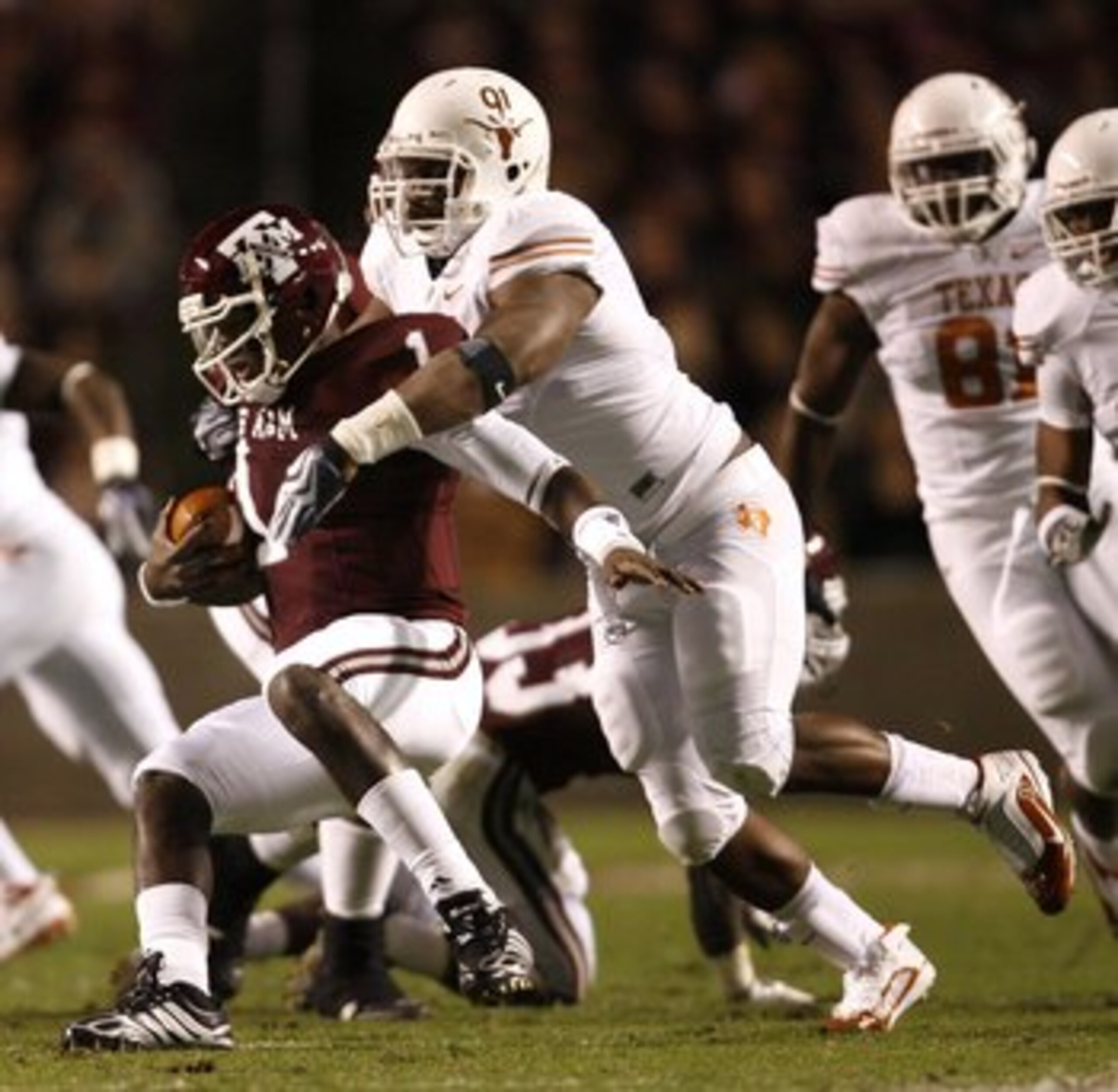 COLLEGE STATION, TX - NOVEMBER 26: Defensive tackle Kheeston Randall #91 of the Texas Longhorns sacks quarterback Jerrod Johnson #1 of the Texas A&M Aggies for a loss in the first half at Kyle Field on November 26, 2009 in College Station, Texas. The Long