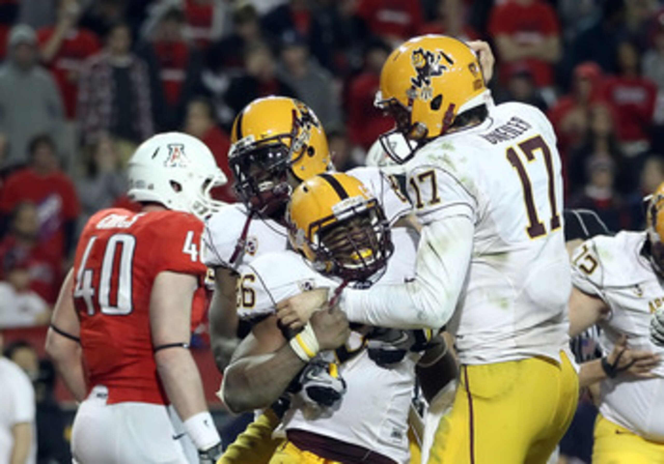 TUCSON, AZ - DECEMBER 02:  Quarterback Brock Osweiler #17 of the Arizona State Sun Devils celebrates with Cameron Marshall #26 after he scored a rushing touchdown against the Arizona Wildcats during the double overtime of the college football game at Ariz