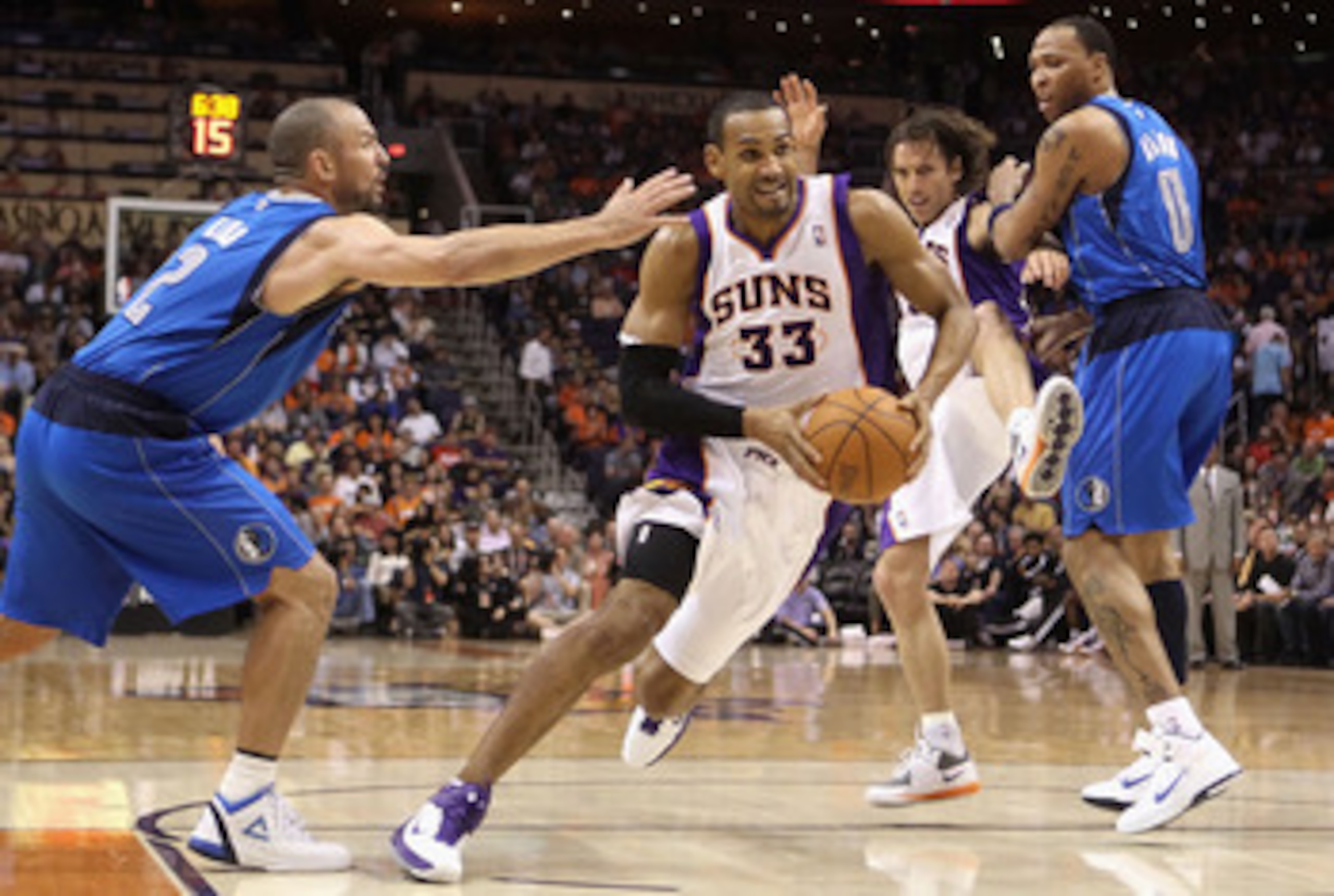 PHOENIX, AZ - MARCH 27:  Grant Hill  #33 of the Phoenix Suns drives the ball past  Jason Kidd #2 of the Dallas Mavericks during the NBA game at US Airways Center on March 27, 2011 in Phoenix, Arizona.  The Mavericks defeated the Suns 91-83.  NOTE TO USER: