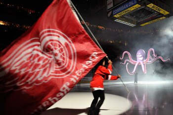 DETROIT - MAY 4:  Pregame ceremonies before Game Three of the Western Conference Semifinals between the San Jose Sharks and the Detroit Red Wings included an octopus dropping from the scoreboard and skaters with flags during the 2011 NHL Stanley Cup Playo