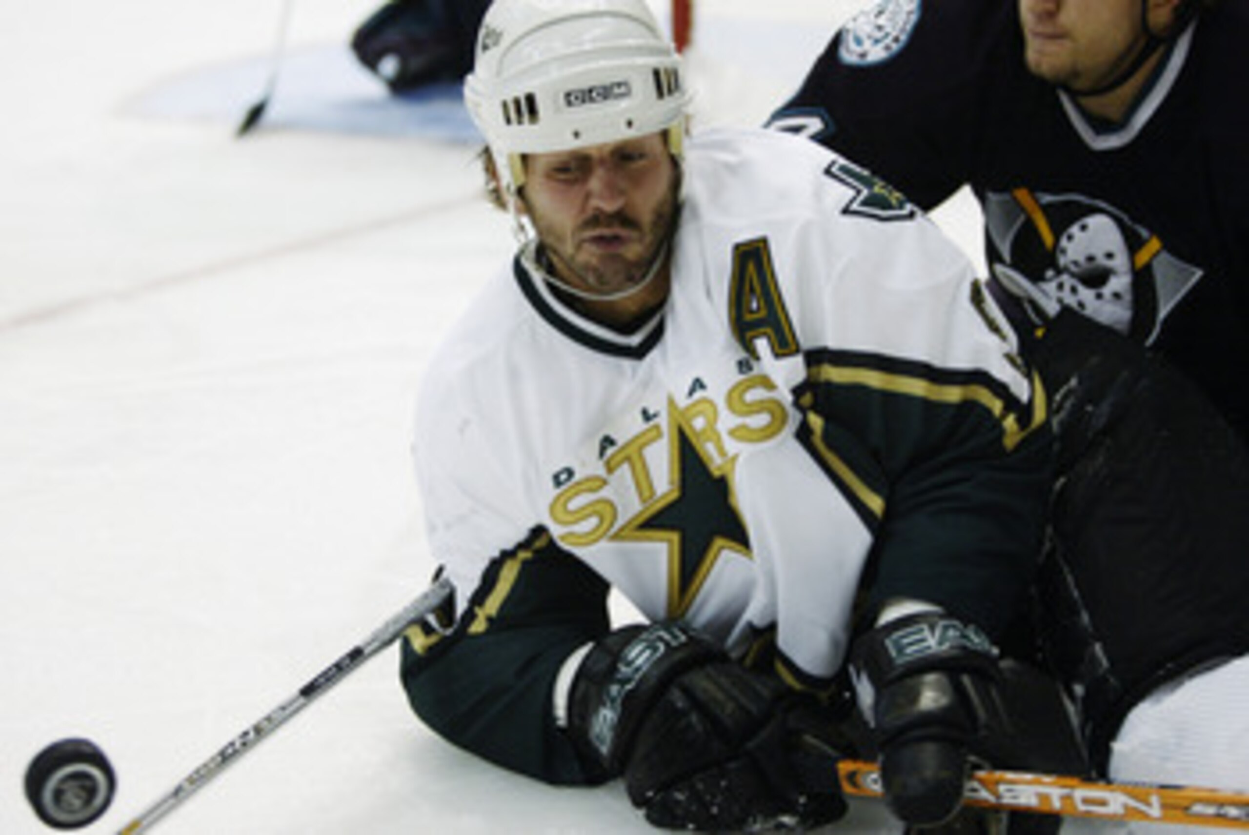 DALLAS - MAY 3:  Mike Madano #9 of the Dallas Stars struggles for control of the puck with Ruslan Salei #24 of the Mighty Ducks of Anaheim in the 2003 Stanley Cup Western Conference semifinals at the American Airlines Center on May 3, 2003 in Dallas, Texa