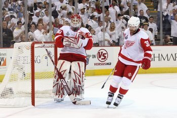PITTSBURGH - JUNE 4:  Goalie Chris Osgood #30 of the Detroit Red Wings with Kris Draper #33 react on the ice against the Pittsburgh Penguins during Game Four of the 2009 NHL Stanley Cup Finals on June 4, 2009 at Mellon Arena in Pittsburgh, Pennsylvania. (