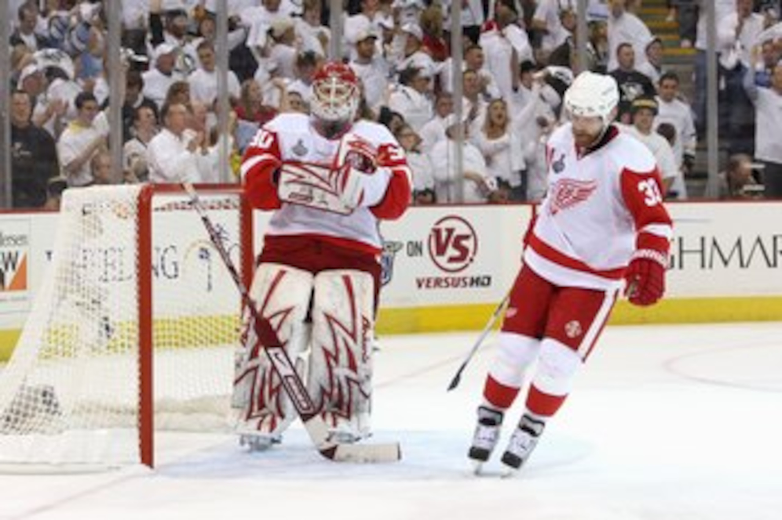 PITTSBURGH - JUNE 4:  Goalie Chris Osgood #30 of the Detroit Red Wings with Kris Draper #33 react on the ice against the Pittsburgh Penguins during Game Four of the 2009 NHL Stanley Cup Finals on June 4, 2009 at Mellon Arena in Pittsburgh, Pennsylvania. (