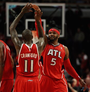 CHICAGO, IL - MAY 02: Josh Smith #5 and Jamal Crawford #11 of the Atlanta Hawks celebrate a win over the Chicago Bulls in Game One of the Eastern Conference Semifinals in the 2011 NBA Playoffs at the United Center on May 2, 2011 in Chicago, Illinois. The
