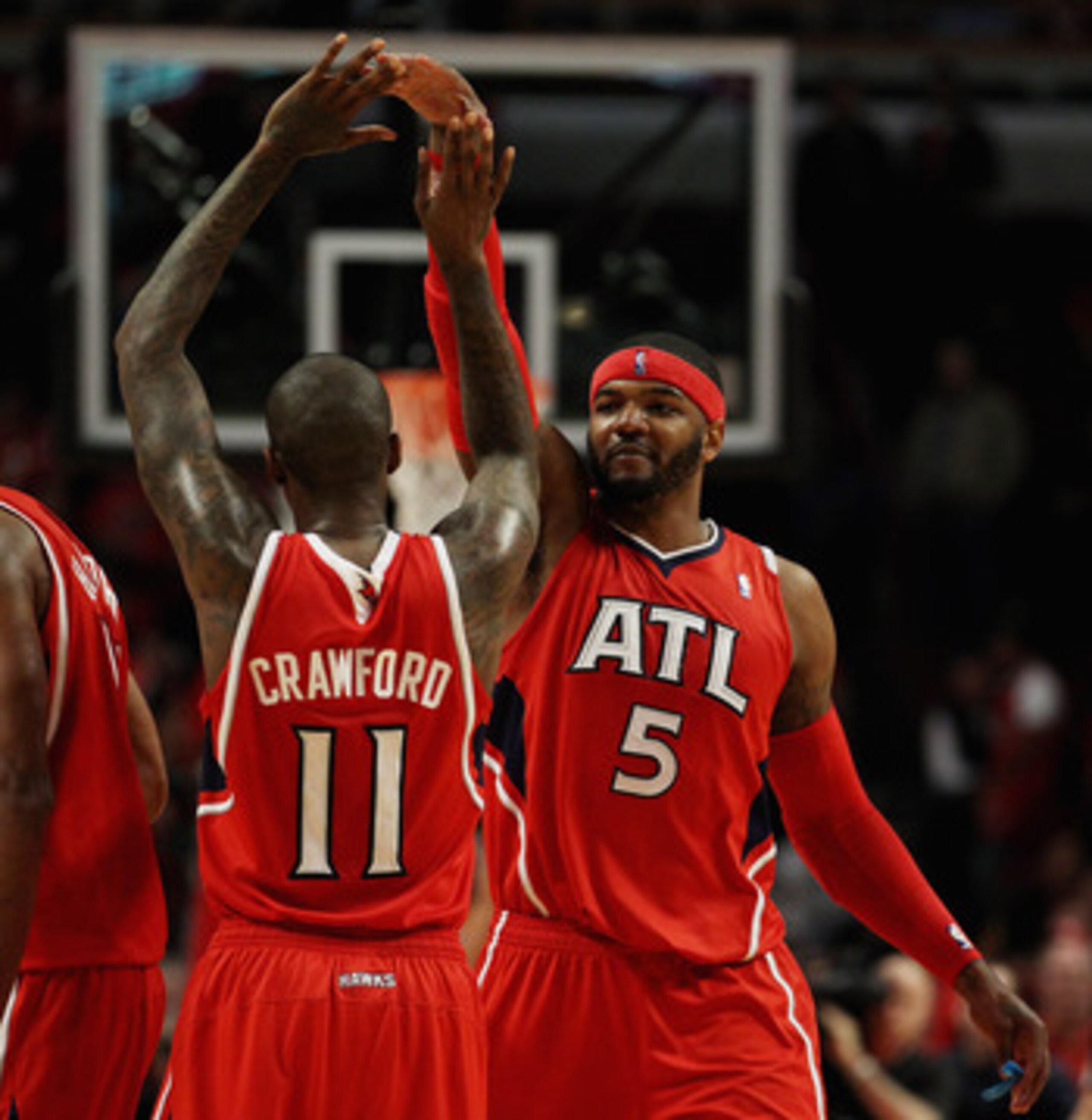 CHICAGO, IL - MAY 02: Josh Smith #5 and Jamal Crawford #11 of the Atlanta Hawks celebrate a win over the Chicago Bulls in Game One of the Eastern Conference Semifinals in the 2011 NBA Playoffs at the United Center on May 2, 2011 in Chicago, Illinois. The