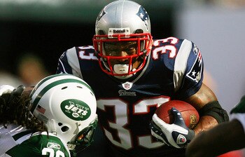EAST RUTHERFORD, NJ - SEPTEMBER 19:  Kyle Wilson #20 of the New York Jets attempts to tackle Kevin Faulk #33 of the New England Patriots during the first quarter at the New Meadowlands Stadium on September 19, 2010 in East Rutherford, New Jersey.  (Photo