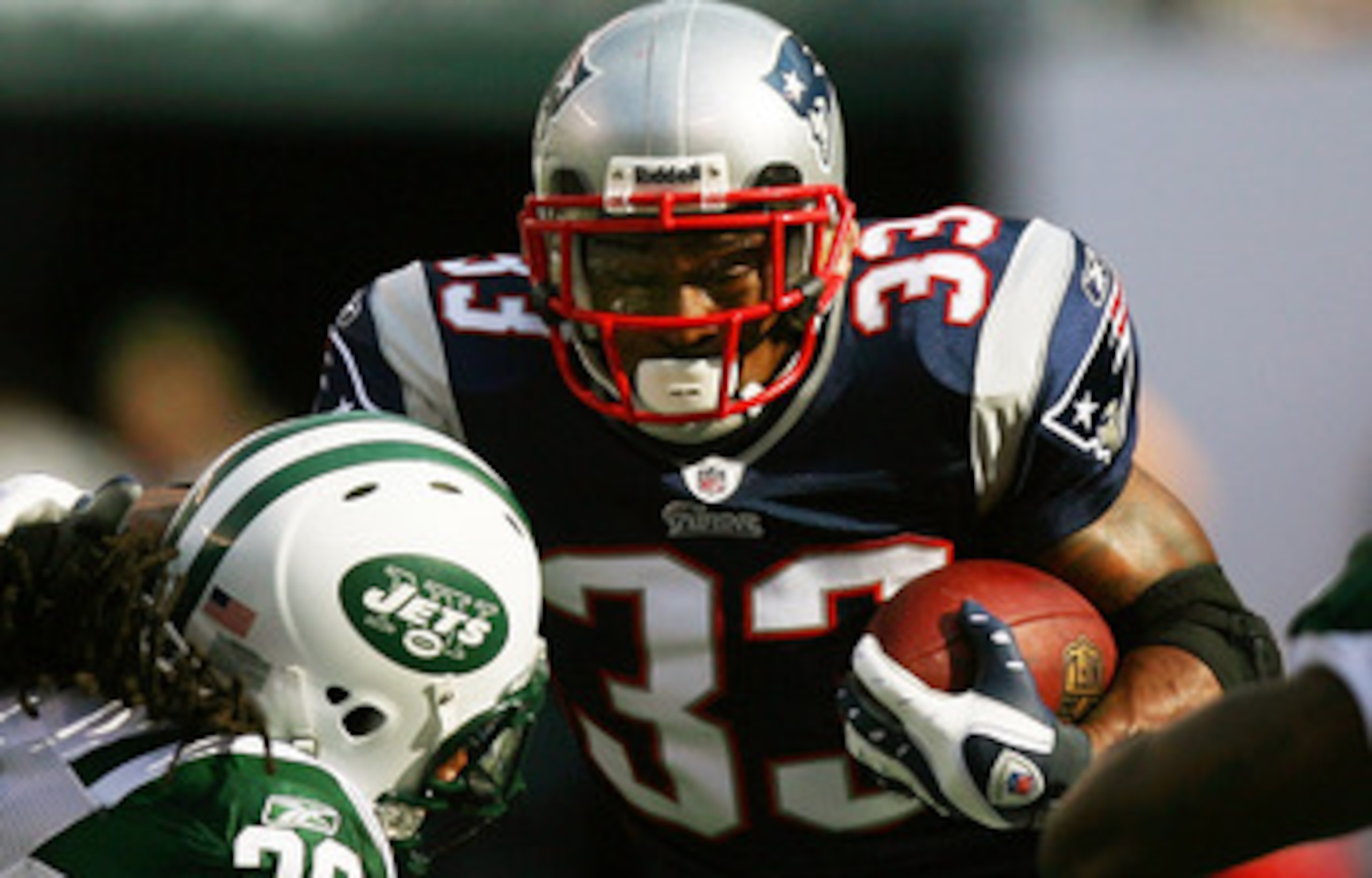 EAST RUTHERFORD, NJ - SEPTEMBER 19:  Kyle Wilson #20 of the New York Jets attempts to tackle Kevin Faulk #33 of the New England Patriots during the first quarter at the New Meadowlands Stadium on September 19, 2010 in East Rutherford, New Jersey.  (Photo