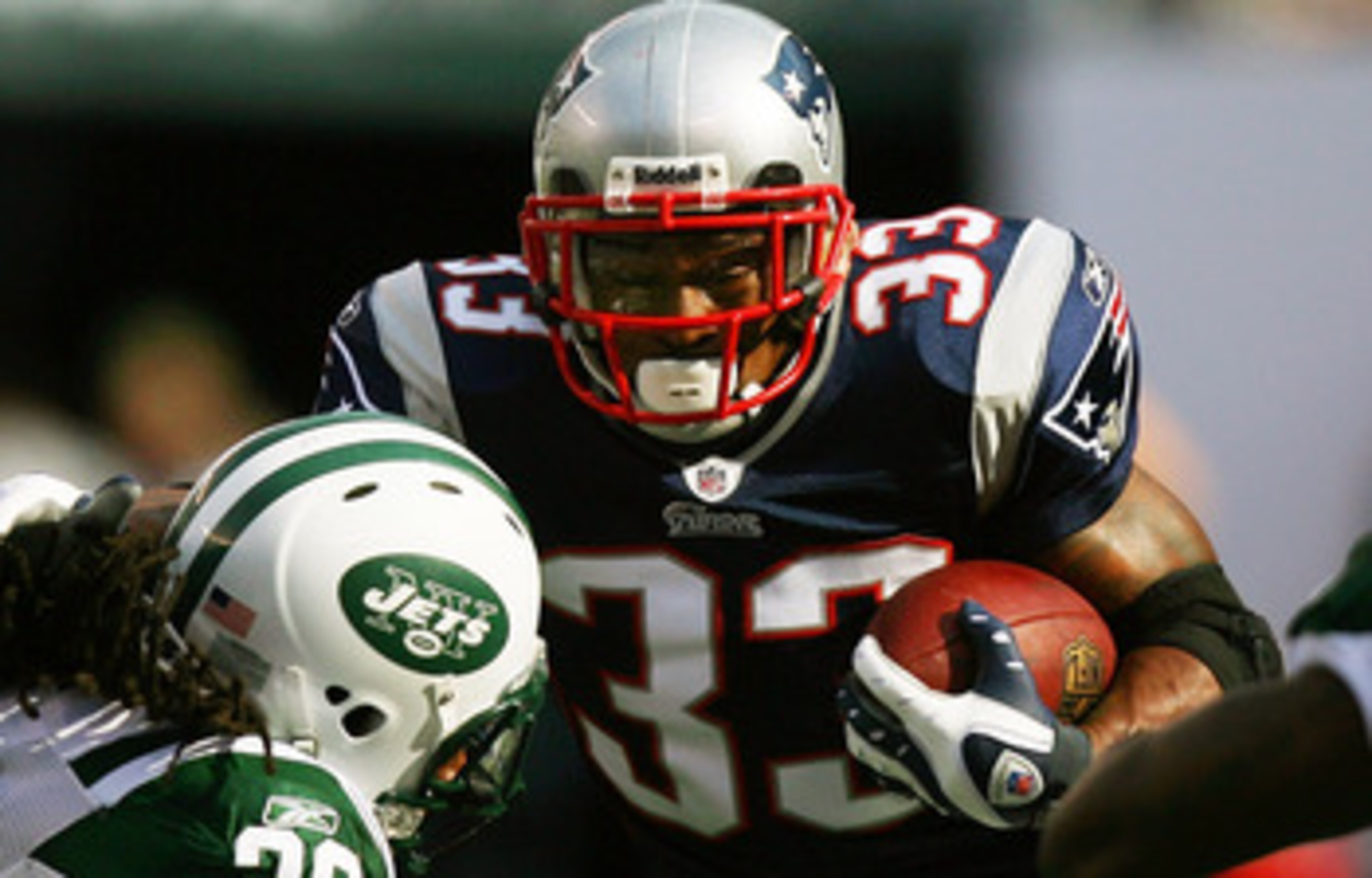 EAST RUTHERFORD, NJ - SEPTEMBER 19:  Kyle Wilson #20 of the New York Jets attempts to tackle Kevin Faulk #33 of the New England Patriots during the first quarter at the New Meadowlands Stadium on September 19, 2010 in East Rutherford, New Jersey.  (Photo