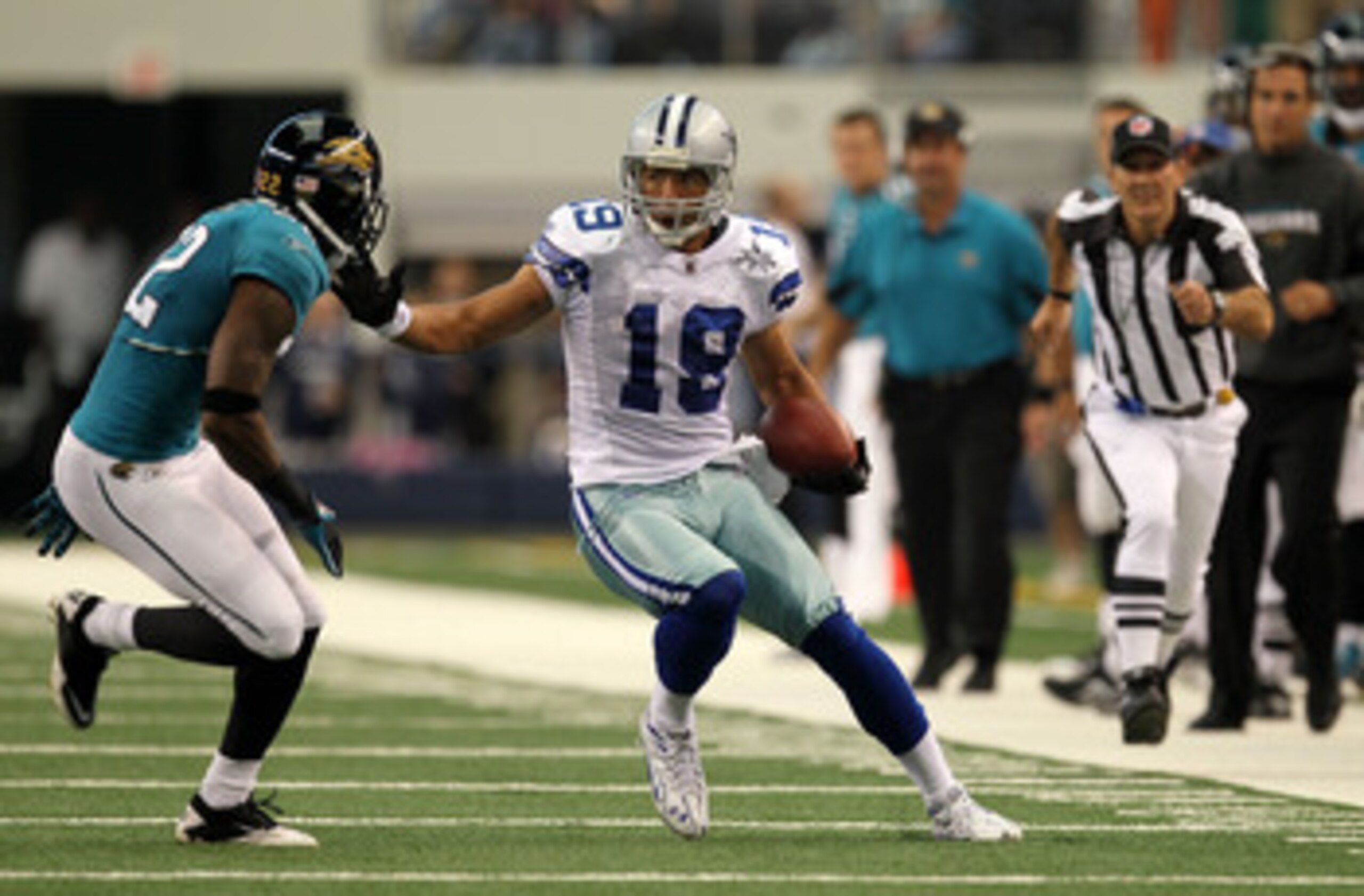 ARLINGTON, TX - OCTOBER 31:  Miles Austin #19 of the Dallas Cowboys runs for yards after the catch against Don Carey #22 of the Jacksonville Jaguars at Cowboys Stadium on October 31, 2010 in Arlington, Texas.  (Photo by Stephen Dunn/Getty Images)