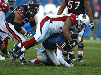 CHICAGO - NOVEMBER 08: Jay Cutler #6 of the Chicago Bears is sacked by Will Davis #59 and flattened by Alan Branch #78 of the Arizona Cardinals at Soldier Field on November 8, 2009 in Chicago, Illinois. The Cardinals defeated the Bears 41-21.  (Photo by J