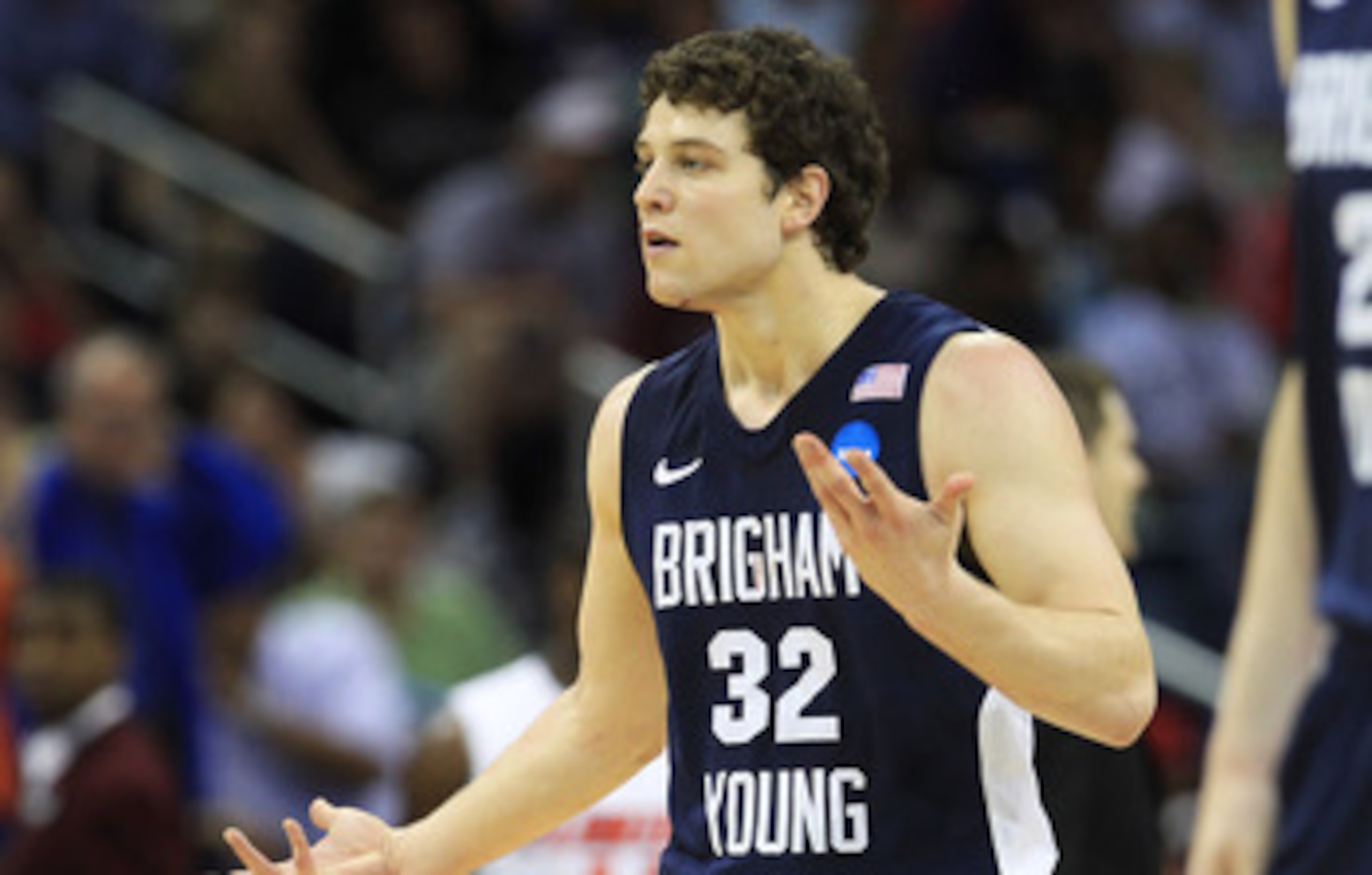 NEW ORLEANS, LA - MARCH 24:  Jimmer Fredette #32 of the Brigham Young Cougars reacts after being injured during their game against the Florida Gators in the Southeast regional of the 2011 NCAA men's basketball tournament at New Orleans Arena on March 24, 