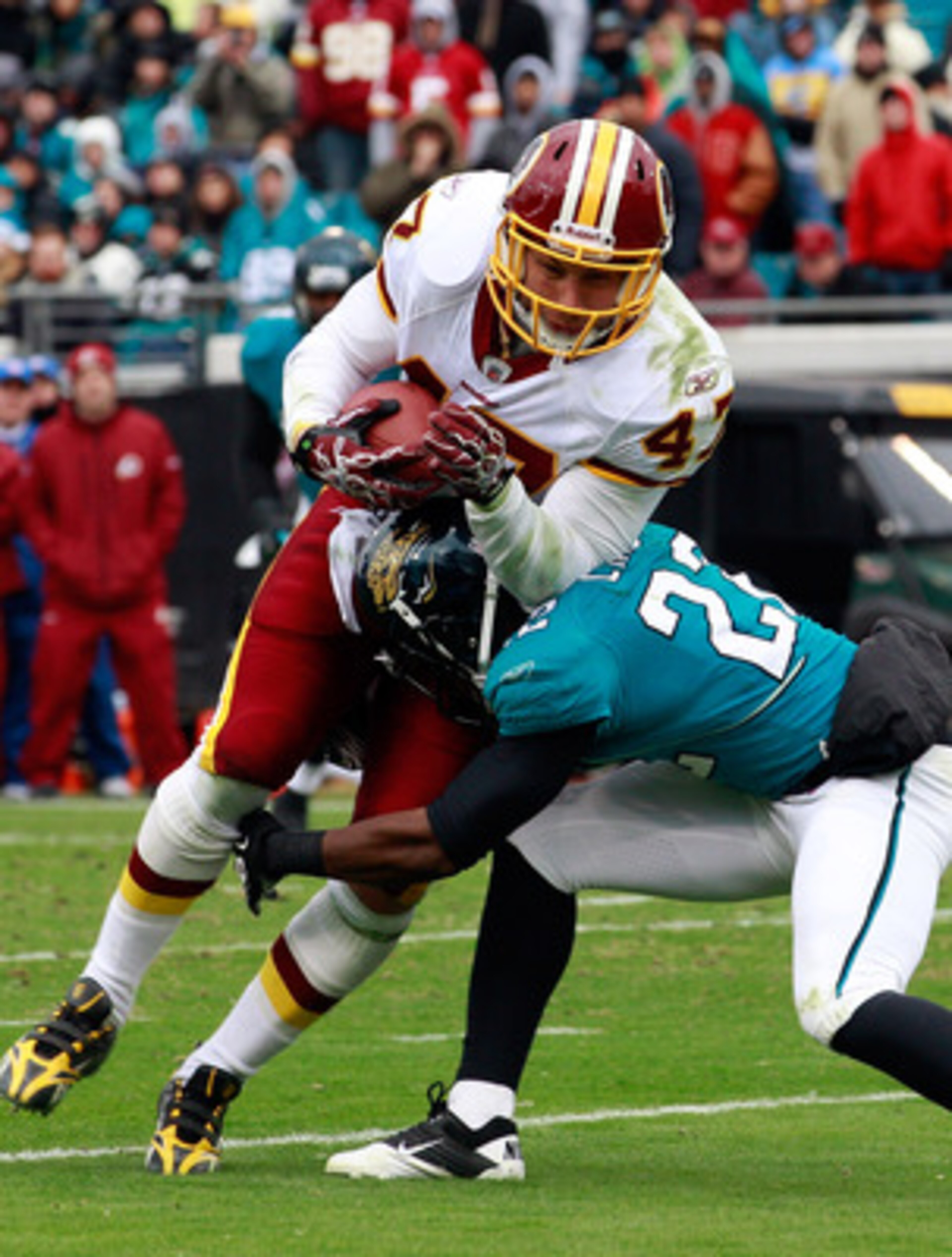 JACKSONVILLE, FL - DECEMBER 26:  Don Carey #22 of the Jacksonville Jaguars attempts to tackle Chris Cooley #47 of the Washington Redskins during the game at EverBank Field on December 26, 2010 in Jacksonville, Florida.  (Photo by Sam Greenwood/Getty Image