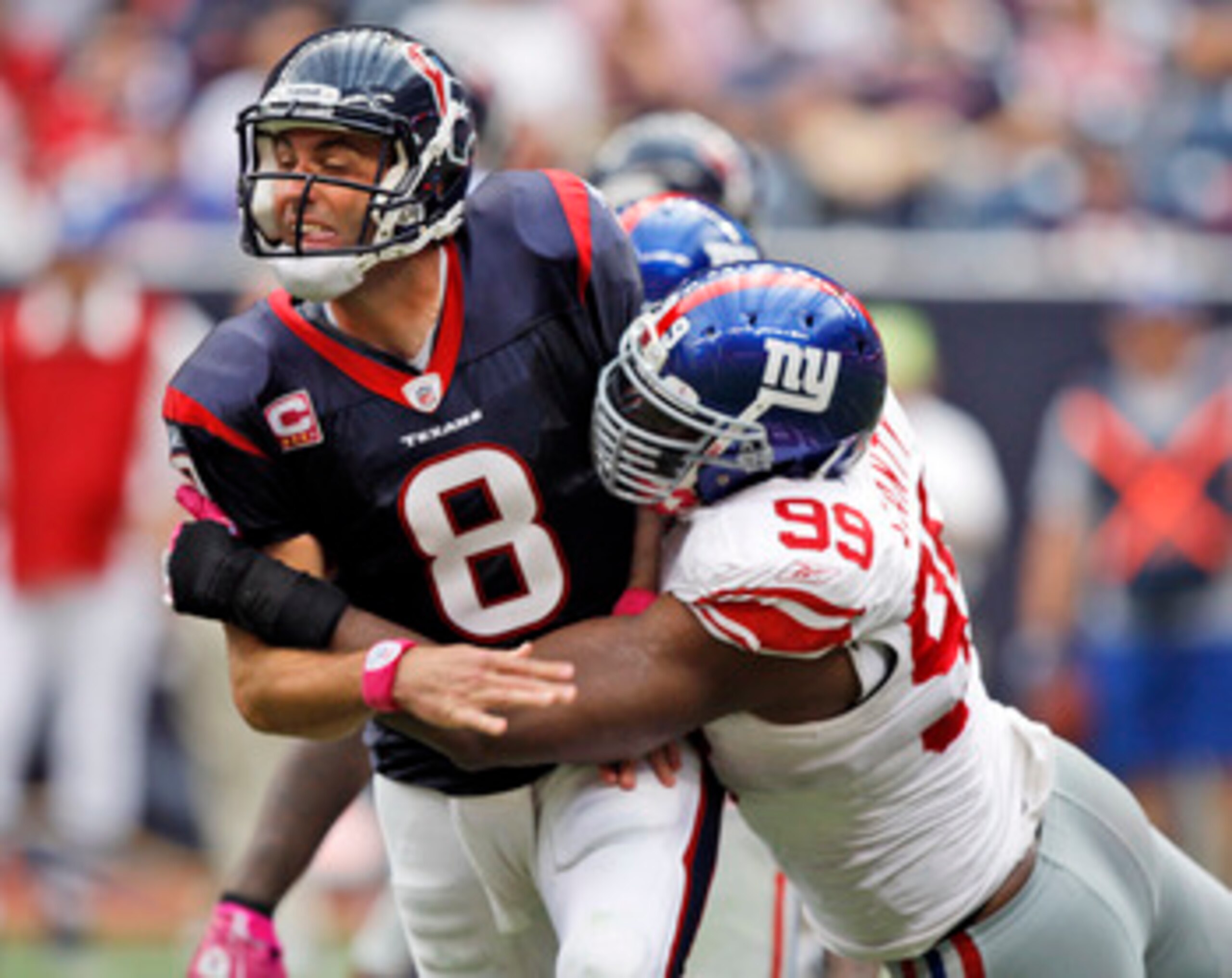 HOUSTON - OCTOBER 10:  Quarterback Matt Schaub #8 of the Houston Texans is hit by defensive tackle Chris Canty #99 of the New York Giants at Reliant Stadium on October 10, 2010 in Houston, Texas.  (Photo by Bob Levey/Getty Images)
