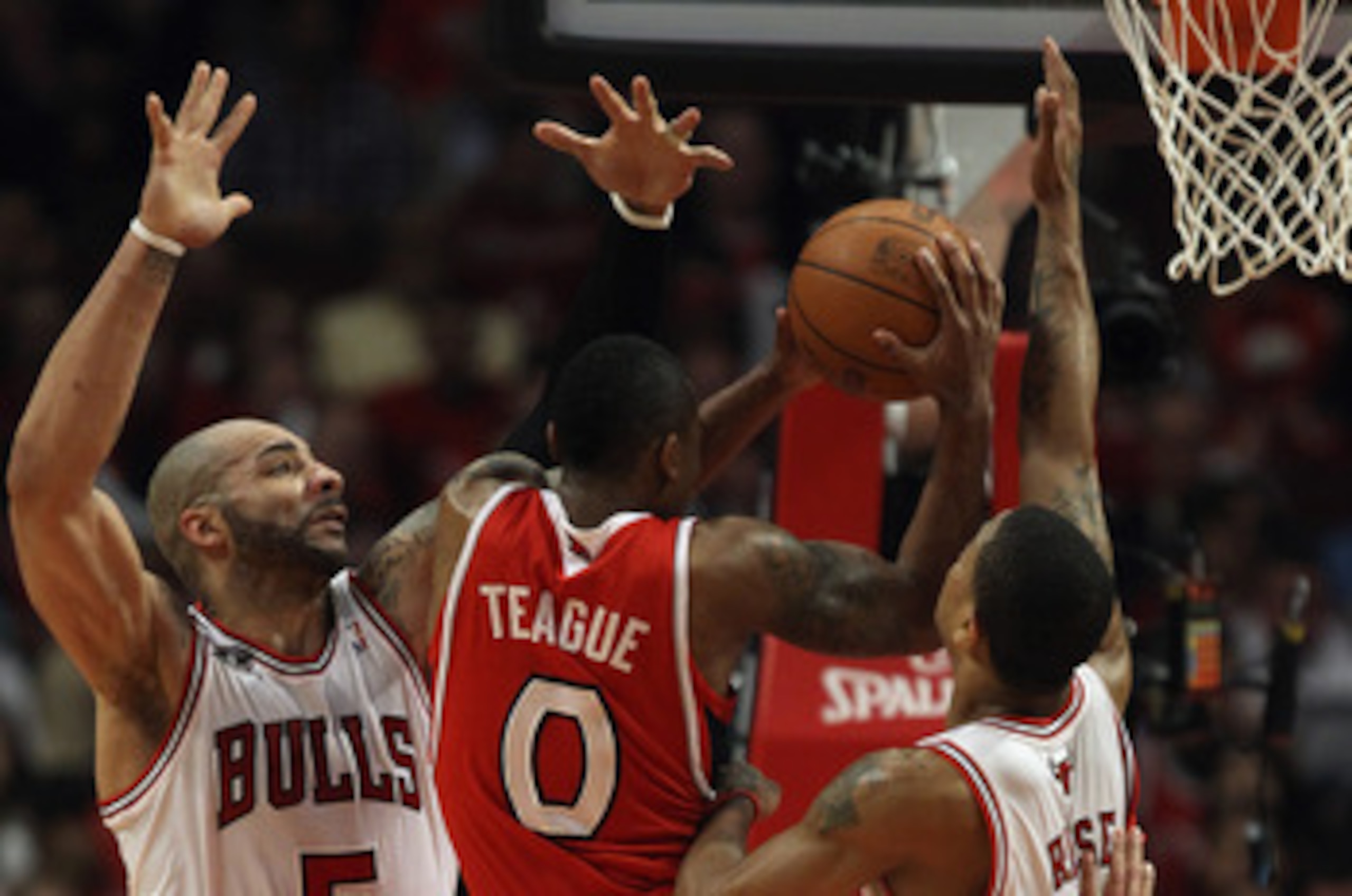 CHICAGO, IL - MAY 04: Jeff Teague #0 of the Atlanta Hawks goes up for a shot under pressure from Carlos Boozer #5 and Derrick Rose #1 of the Chicago Bulls in Game Two of the Eastern Conference Semifinals in the 2011 NBA Playoffs at the United Center on Ma