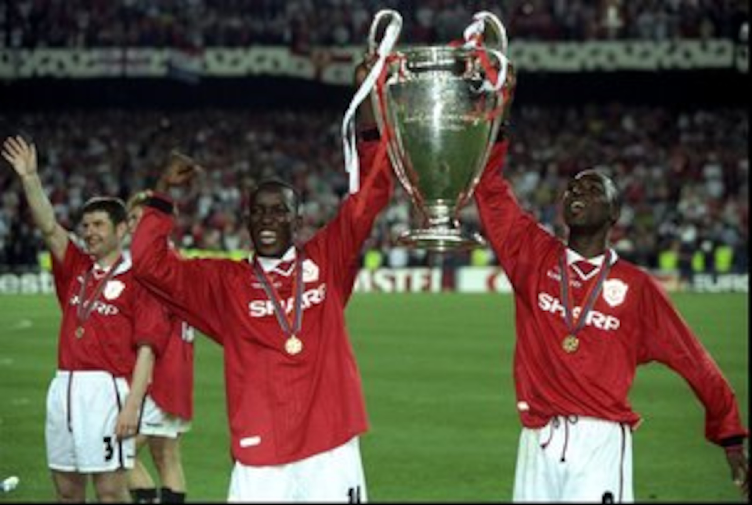26 May 1999:  Dwight Yorke (left) and Andy Cole Of Manchester United  hold the European Cup after beating Bayern Munich in the European Champions League Final in the Nou Camp Stadium, Barcelona, Spain. Manchester United won 2 - 1 with both United goals sc