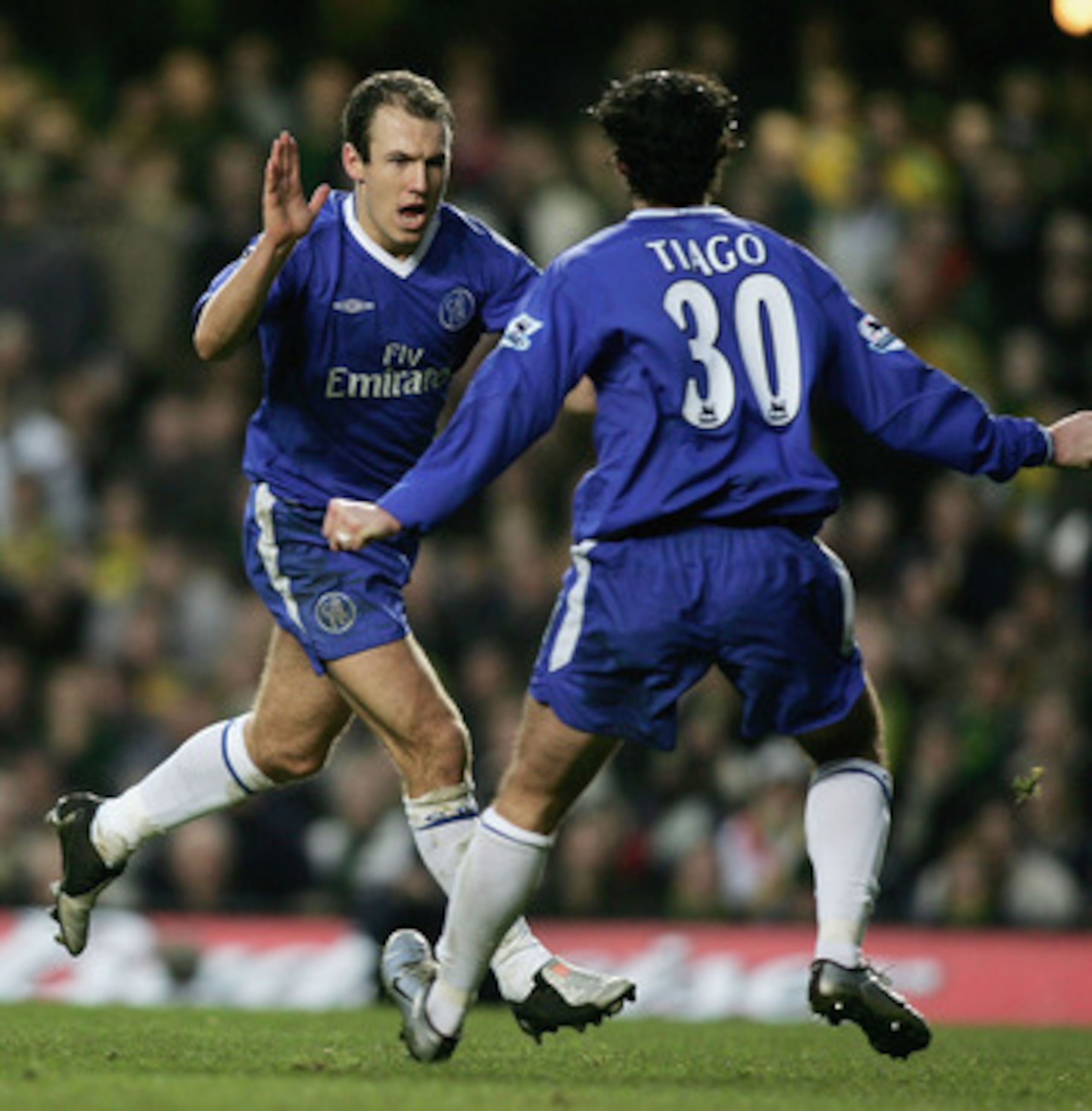 LONDON - DECEMBER 18:  Arjen Robben of Chelsea celebrates scoring his teams third goal with team mate Tiago during the Barclays Premiership match between Chelsea and Norwich City at Stamford Bridge on December 18, 2004 in London, England.  (Photo by Ben R