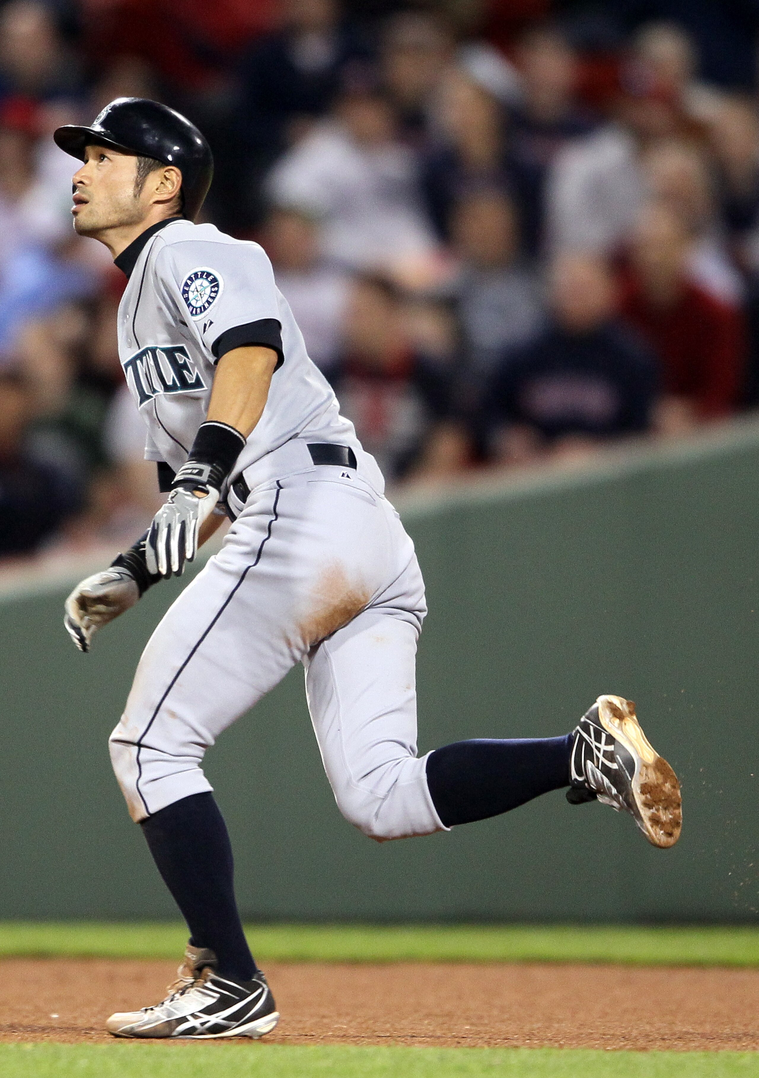 BOSTON, MA - APRIL 30:  Ichiro Suzuki #51 of the Seattle Mariners heads for third base against the Boston Red Sox on April 30, 2011 at Fenway Park in Boston, Massachusetts. The Seattle Mariners defeated the Boston Red Sox 2-0.  (Photo by Elsa/Getty Images