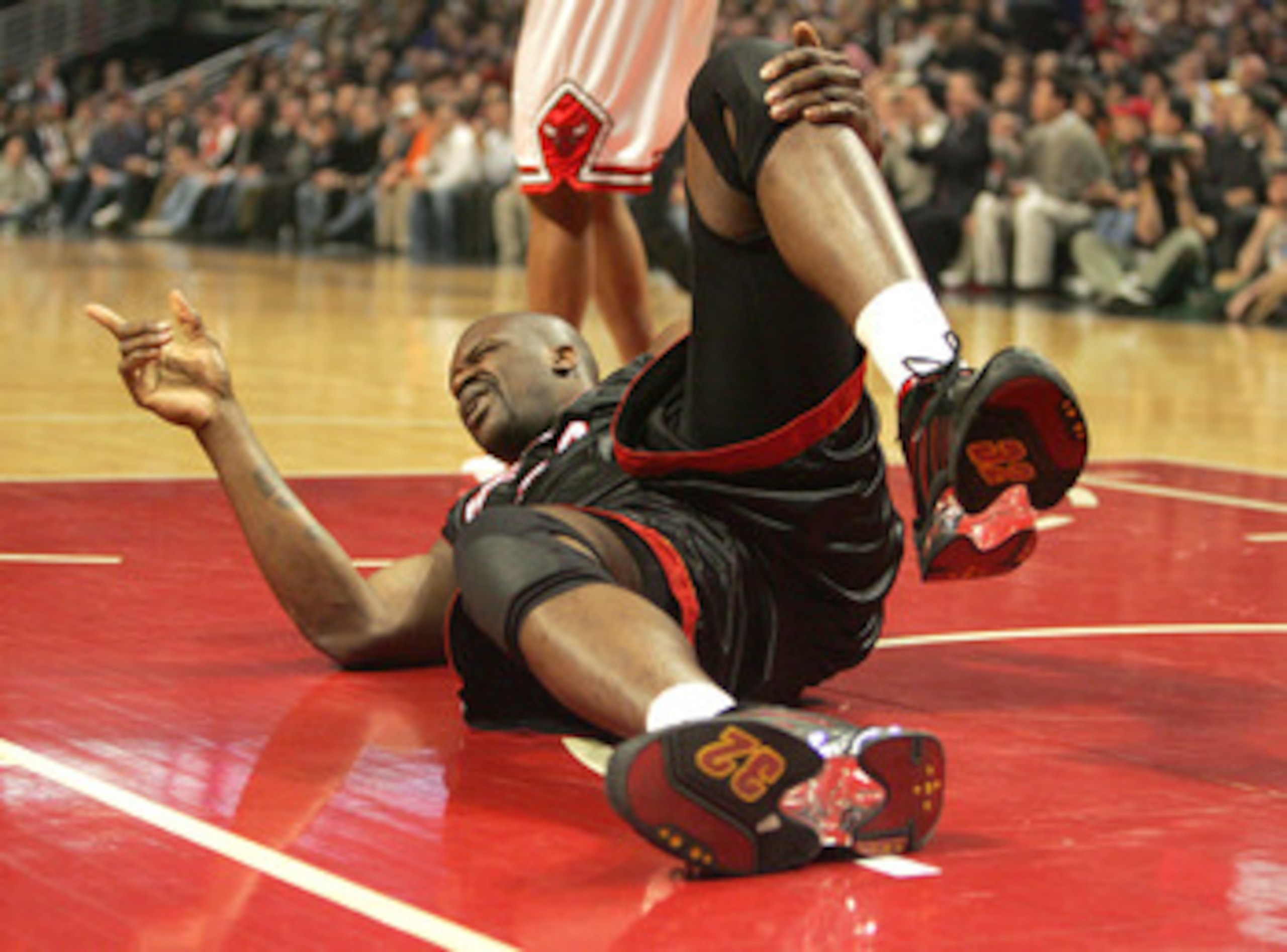 CHICAGO - FEBRUARY 22:  Shaquille O'Neal #32 of the Miami Heat points to the Heat bench after injuring his knee in the first quarter against the Chicago Bulls on February 22, 2005 at the United Center in Chicago, Illinois.  NOTE TO USER: User expressly ac