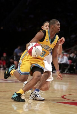 HOUSTON - FEBRUARY 17:  Chris Paul #3 of the Rookie Team drives by Devin Harris #34 of the Sophomore Team during the second half of the T-Mobile Rookie Challenge during NBA All-Star Weekend at the Toyota Center on February 17, 2006 in Houston, Texas. NOTE